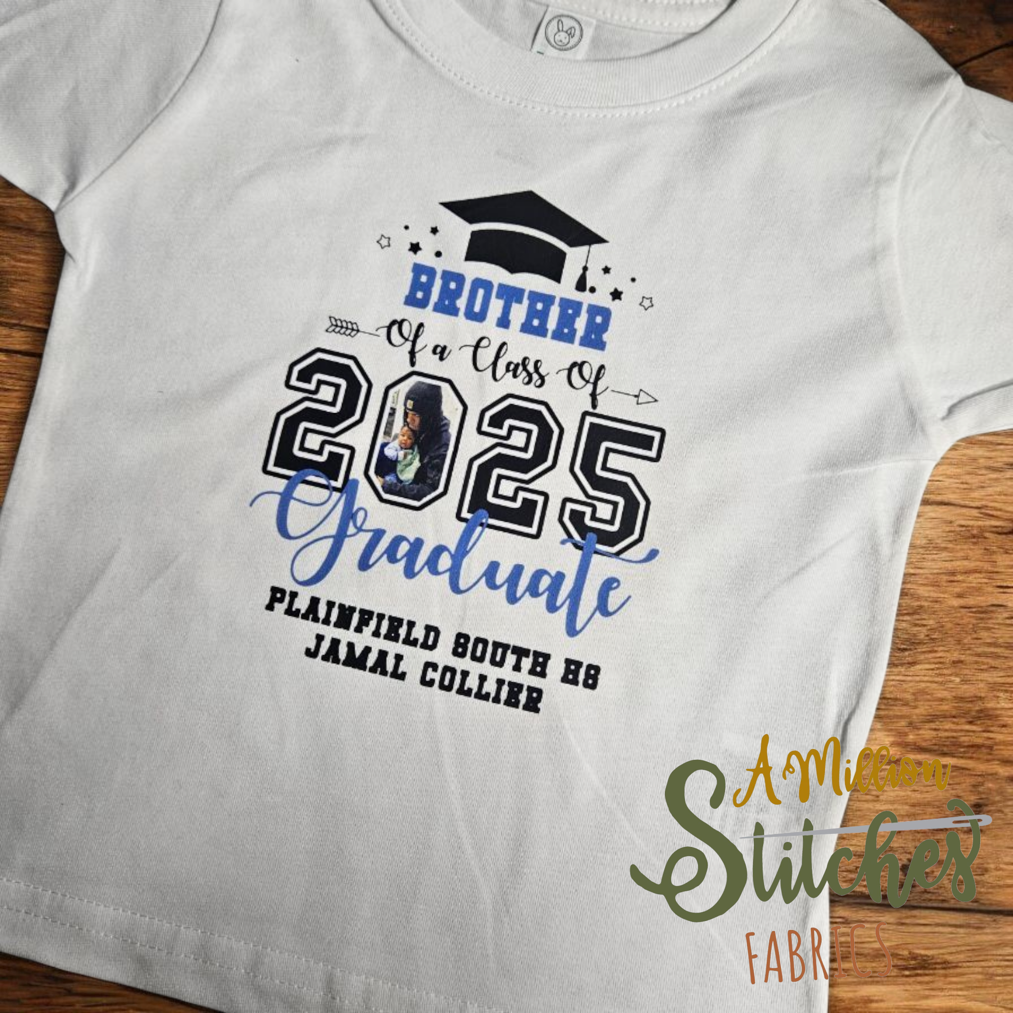 custom White graduation t-shirt with black and blue text, a graduation cap graphic, and a photo of a young girl holding a baby, celebrating graduation in 2025.