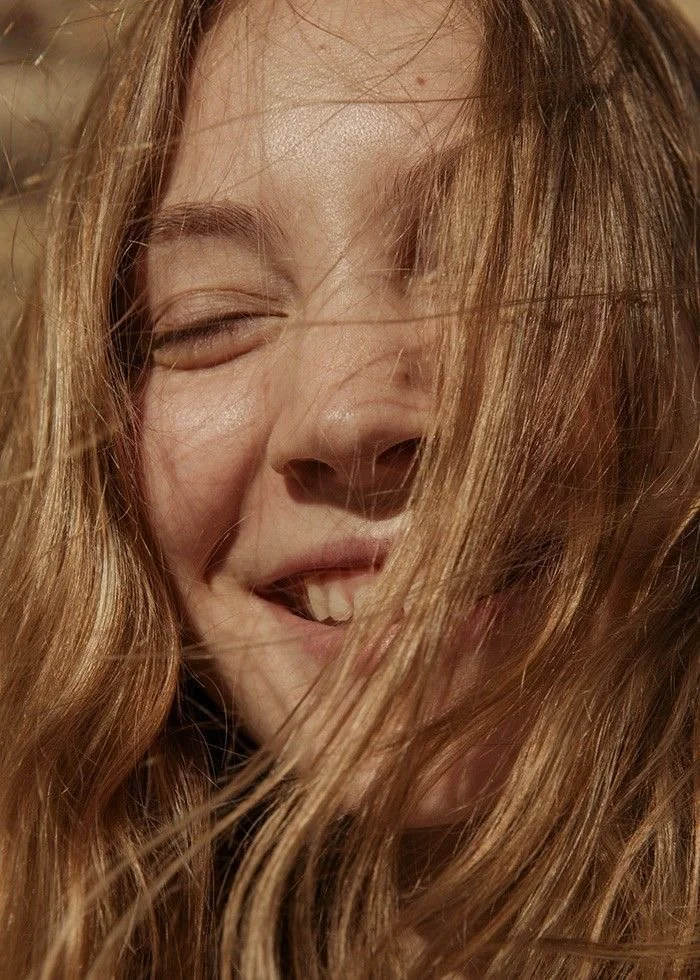 Close-up of a smiling guest with long light brown hair