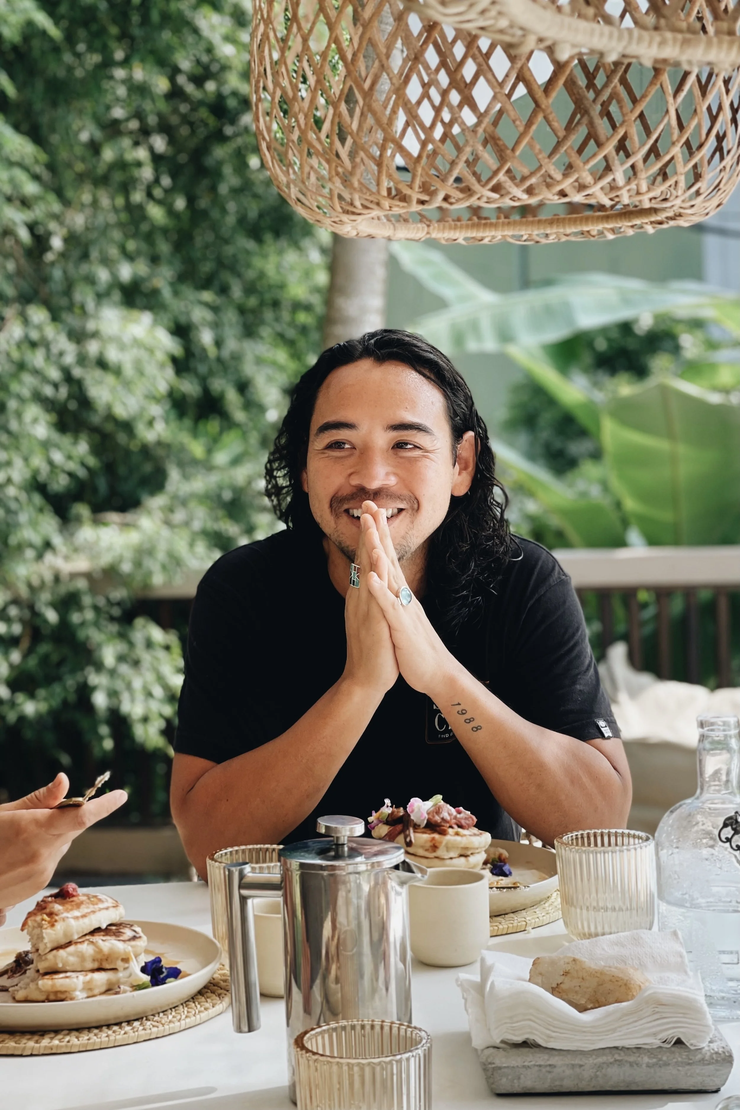 Guest sitting happily in the EarthLinks garden after a meal.