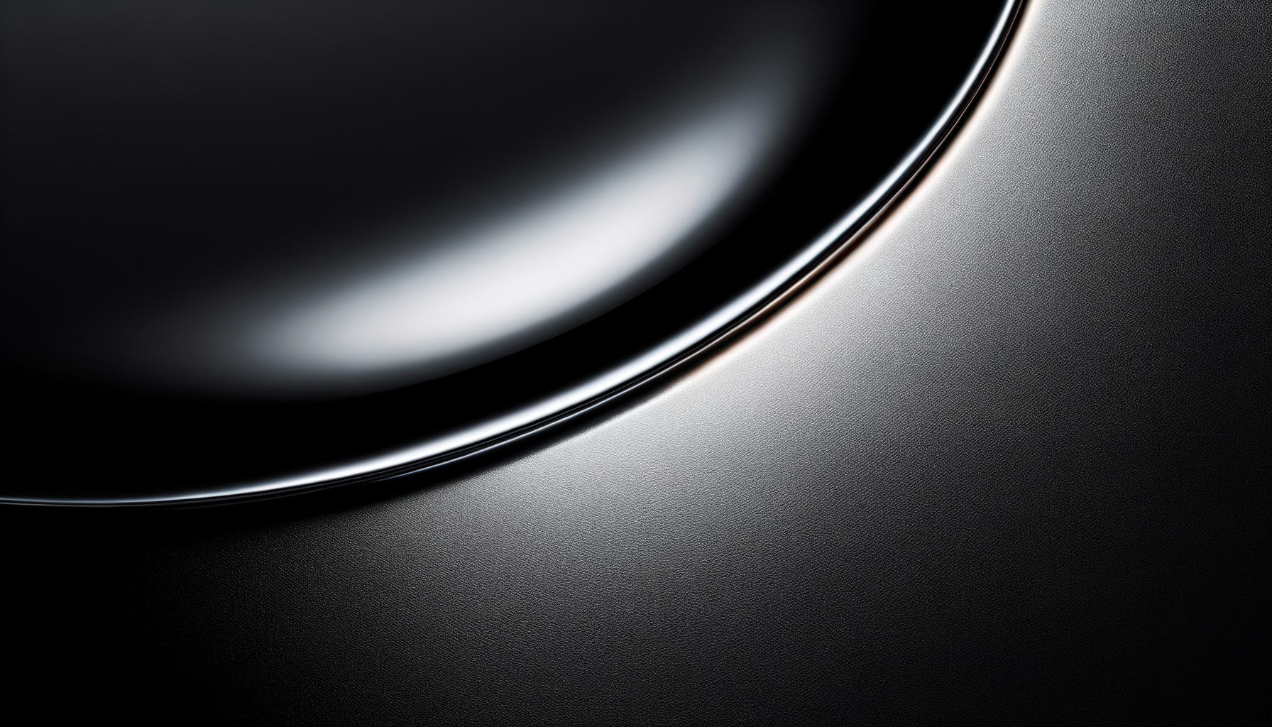 Close-up of a metallic surface with a smooth, curved black shiny object on the top left.