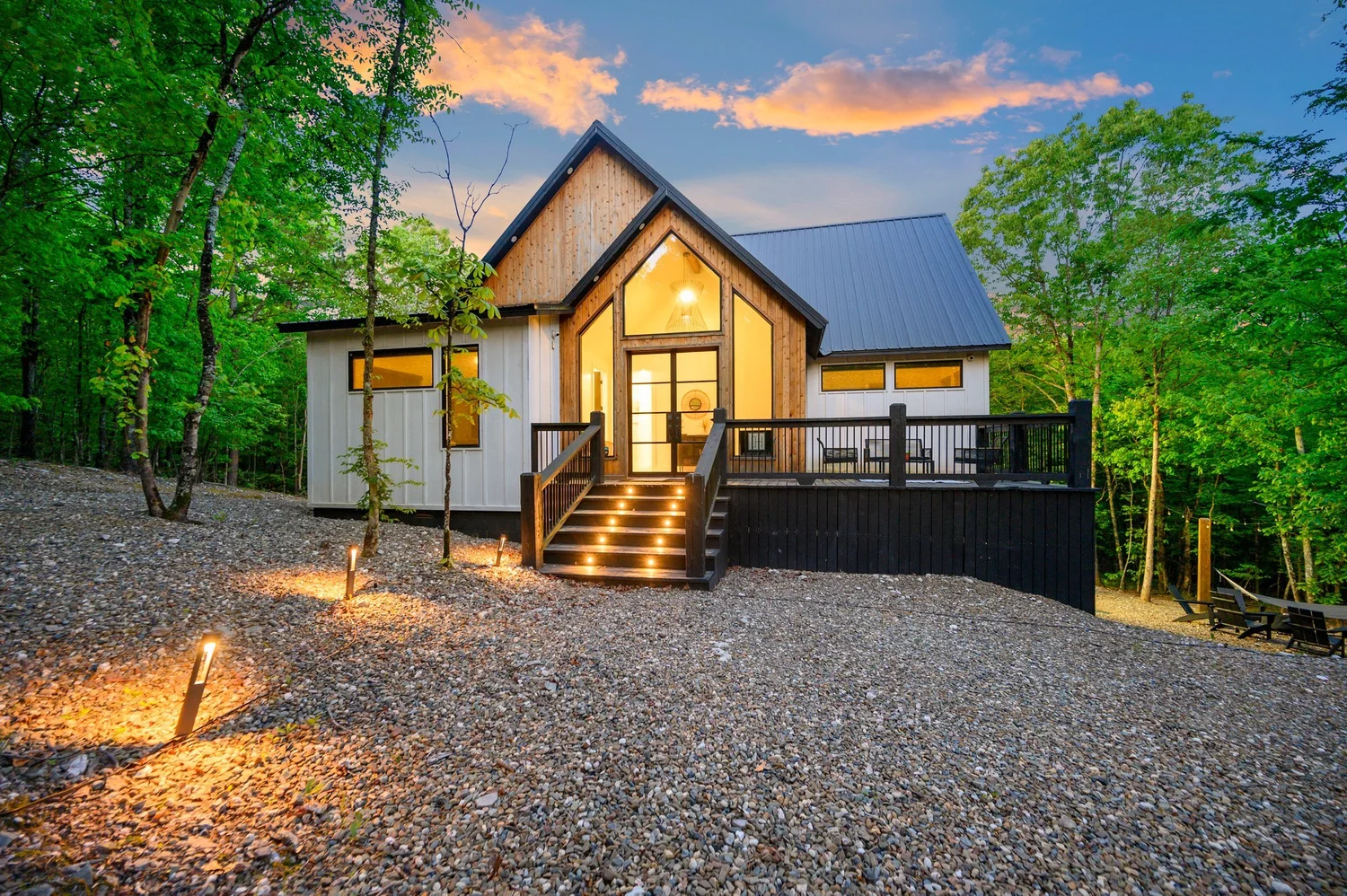 Hygge Hill Cabin glowing at dusk in the pine forest