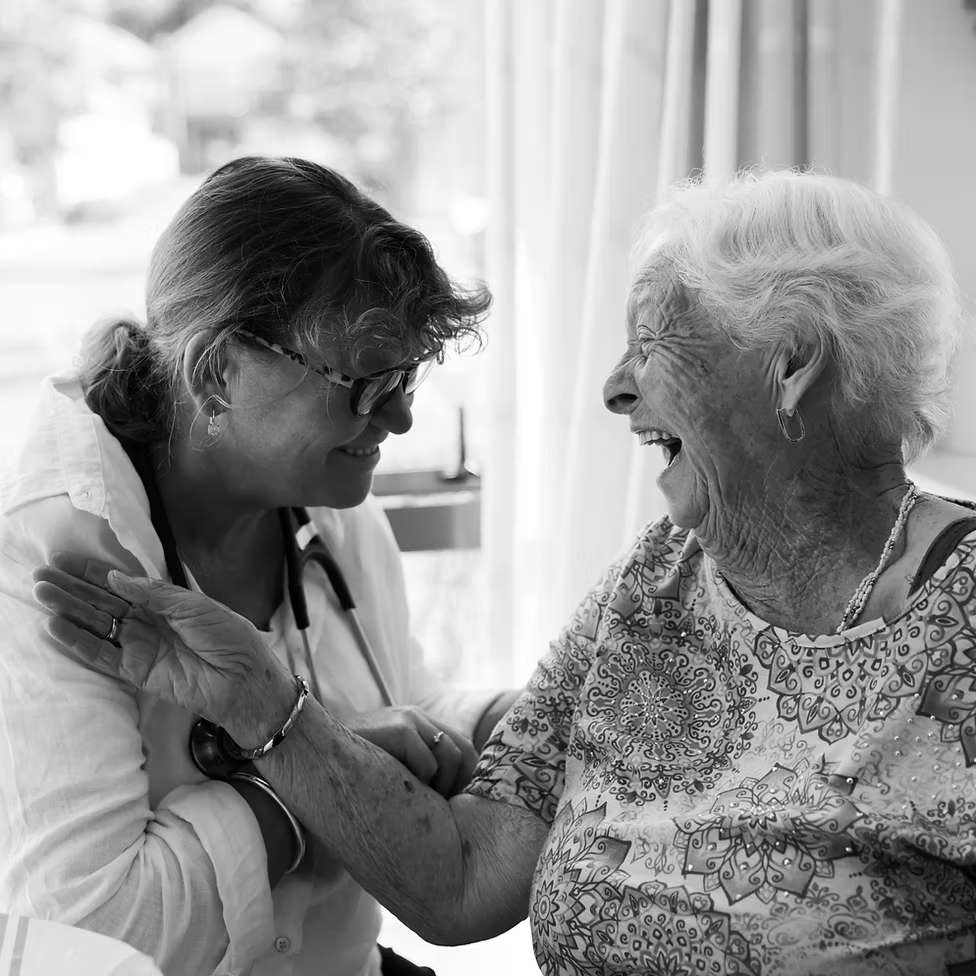 Nurse giving comfort and humour to an elderly women