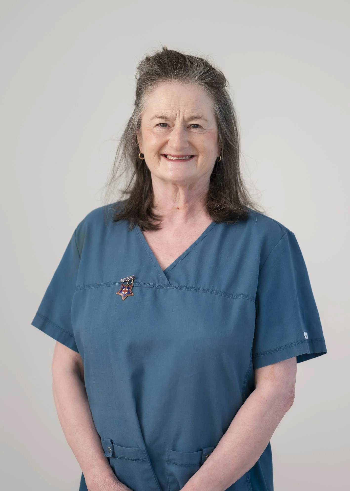 Portrait of Dawn Lee, community nurse, standing against a plain light background. The image conveys empathy, professionalism and partnership-focused care, highlighting her dedication to supporting clients and whānau.