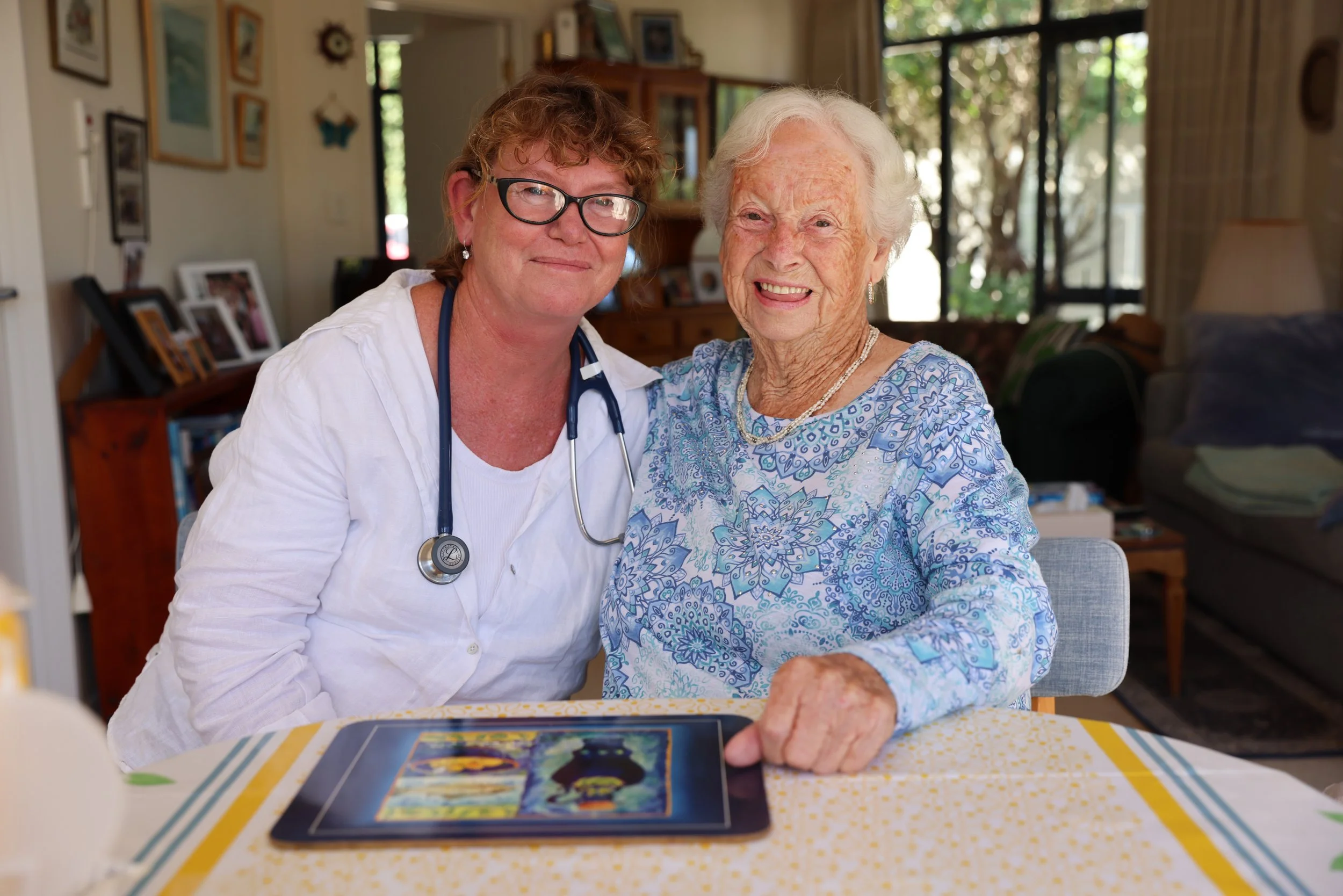 An image of nurse Erica and an eldery patient smiling