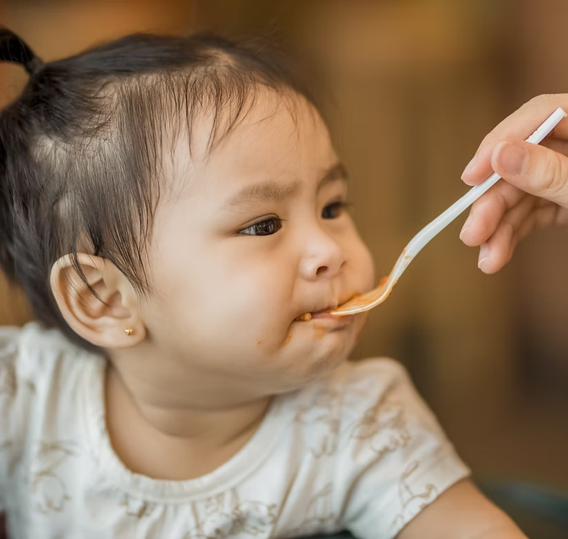 Baby trying food for the first time