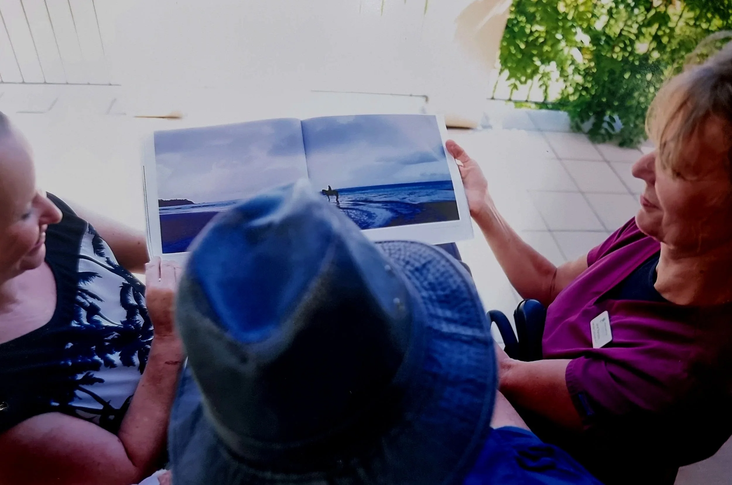 An image of two people looking at a book together