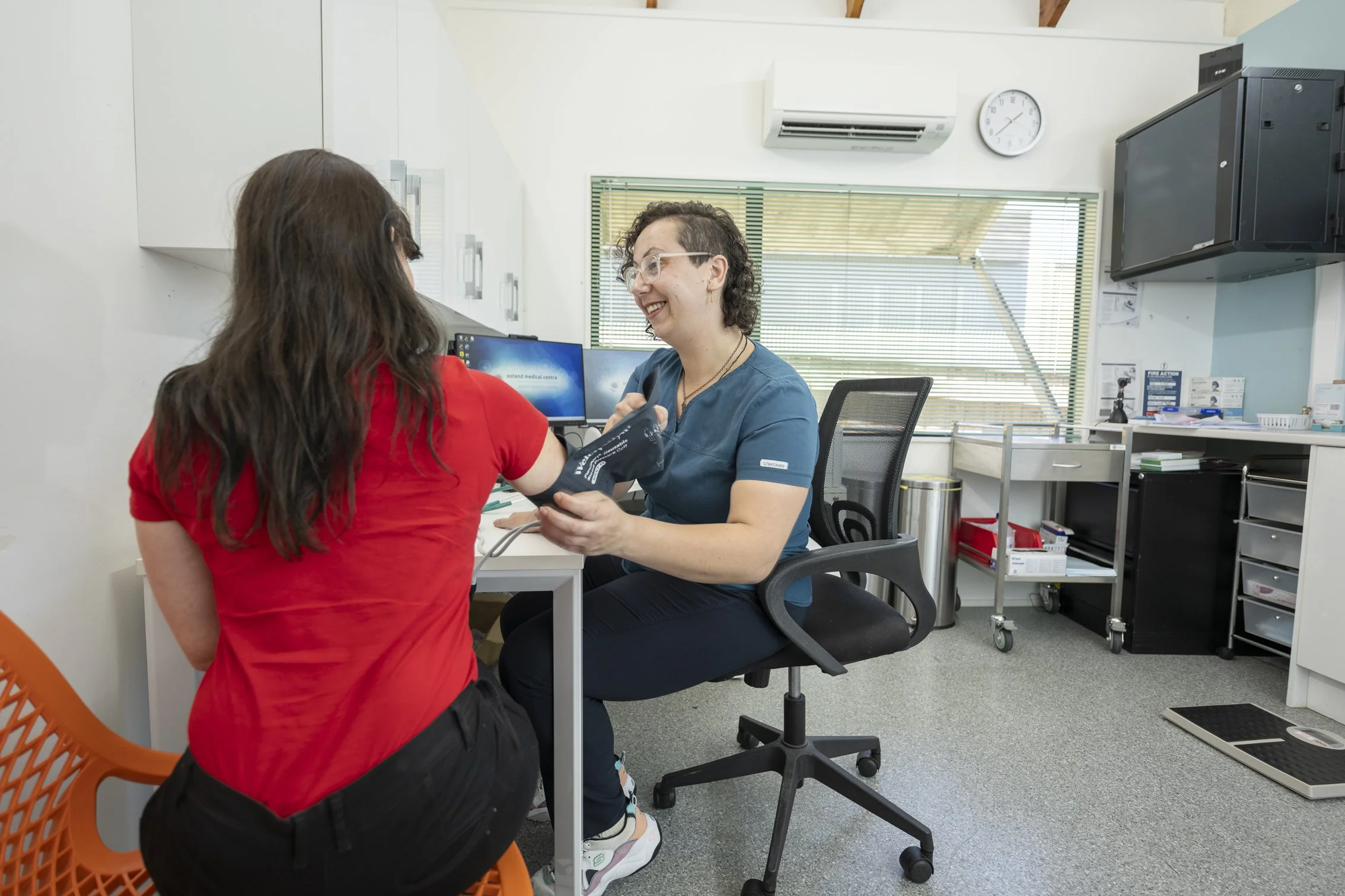 An image of a patient being seen by the nurse at Ostend Medical Centre and checking her blood pressue.