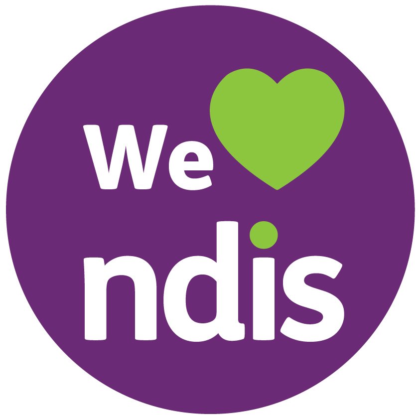 A circular logo with a purple background and white and green text. The text says 'We' and 'ndis,' with a green heart symbol replacing the 'o' in the phrase.