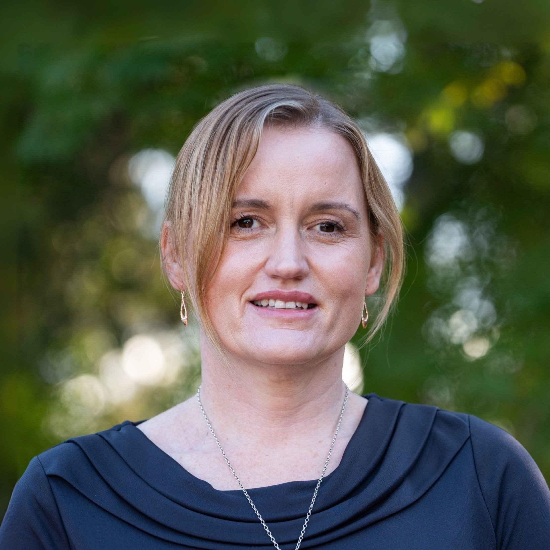 Krystal warmly smiling at camera