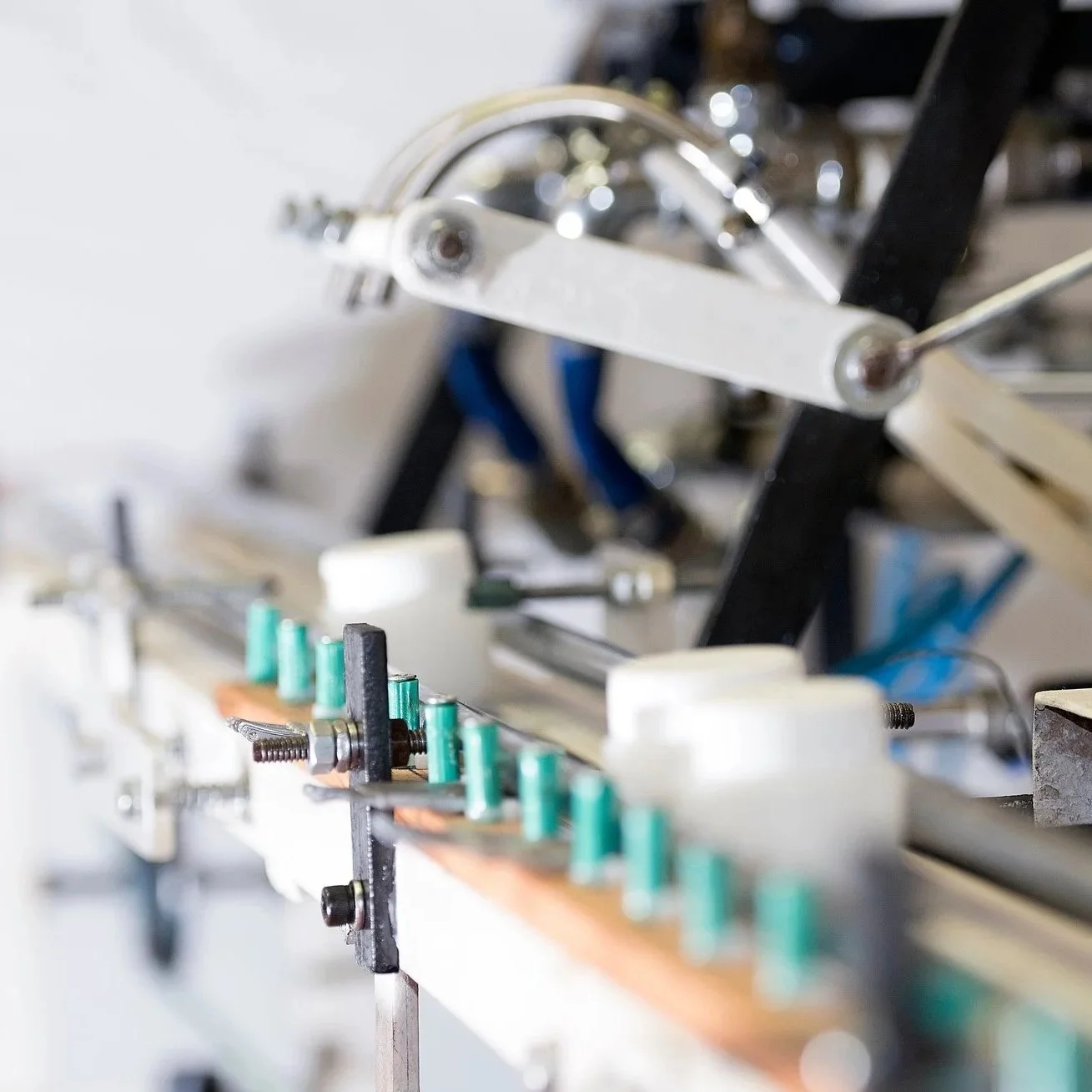 Close-up of mechanical and electronic components on a construction or engineering project, including metal parts, wires, and circuit elements.