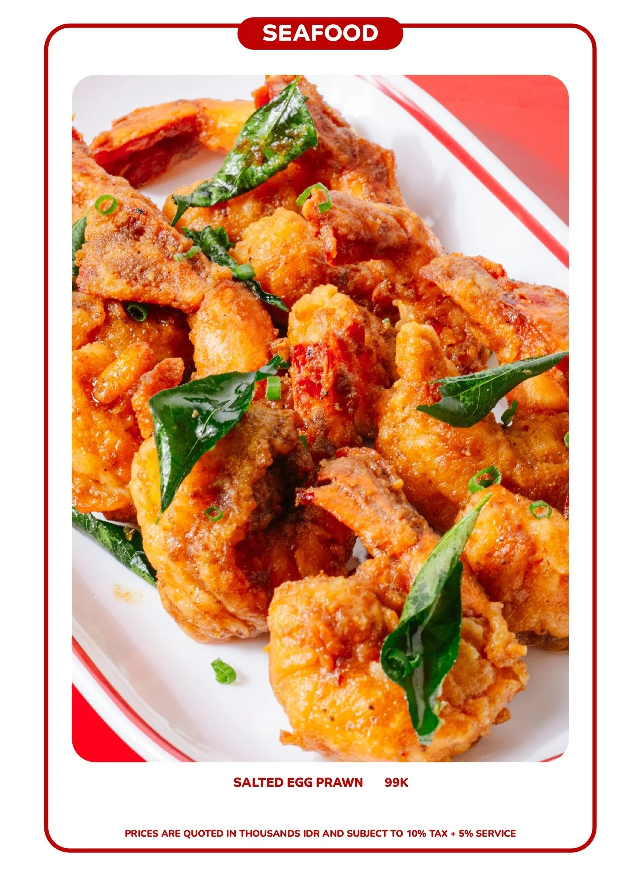 Close-up of fried salted egg prawns garnished with green leaves and chopped green onions, served on a white plate with a red border. Best Chinese food in Canggu Bali