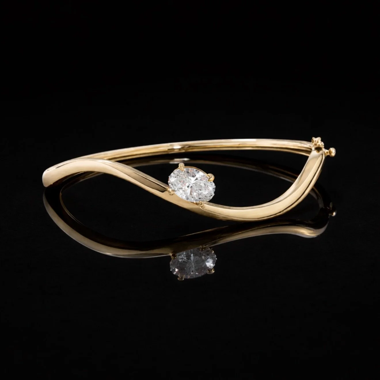 Not your average bangle. Designed to stand out with a flowing silhouette and a perfectly set oval diamond ✨