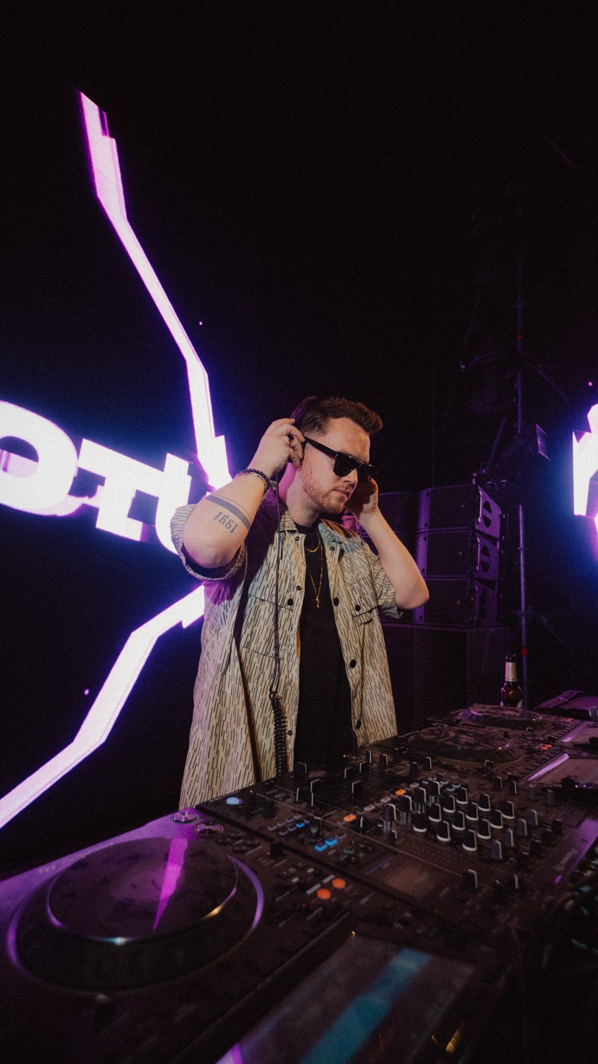 Night-time festival photography of YouNotUs with dramatic lighting and visual effects, shot for electronic music and event promotion.