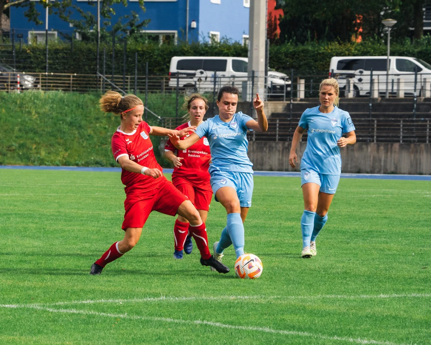 Professional football photography capturing an aerial duel during a Viktoria Berlin league or cup match, emphasizing intensity and physicality.