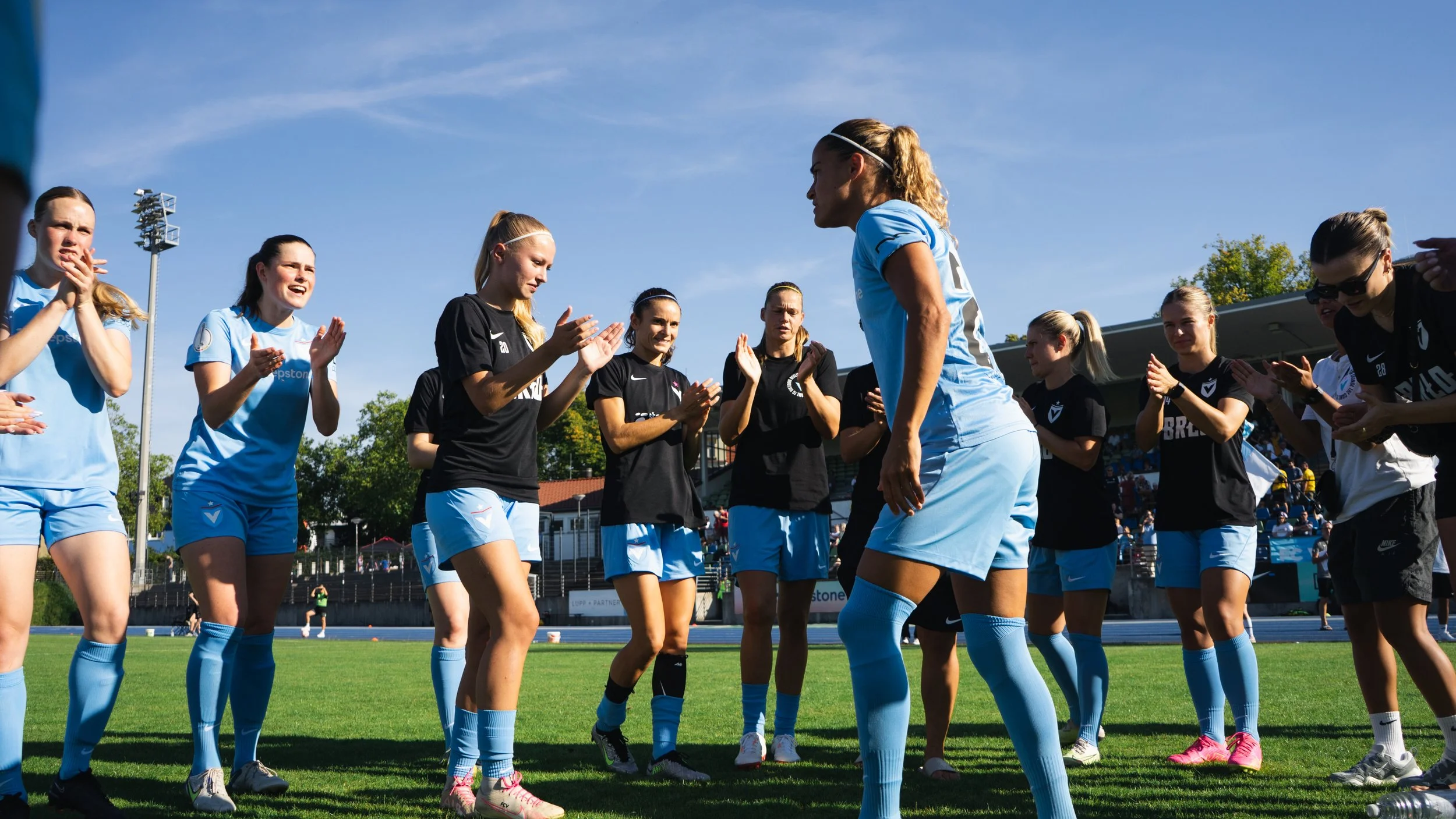 Matchday football photography showing coaching and tactical communication on the sideline during a Viktoria Berlin game.