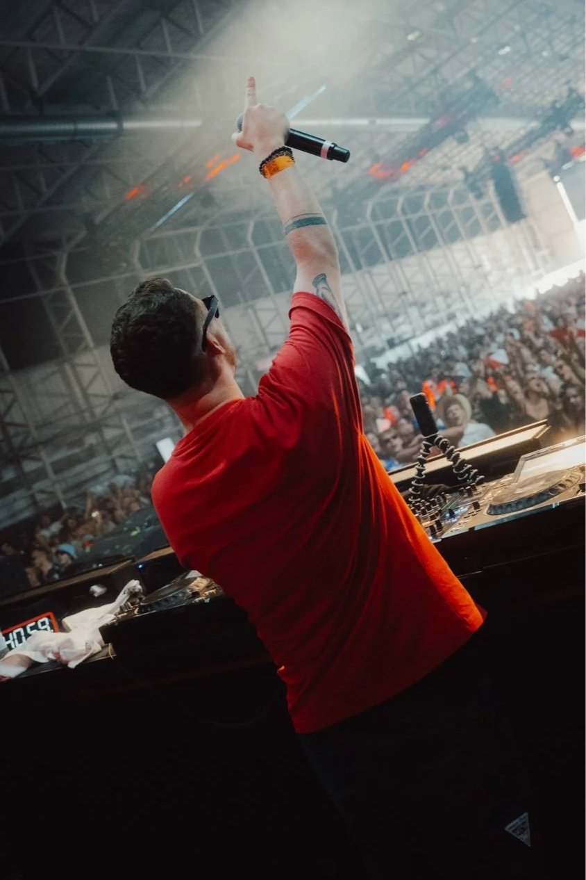 Intimate club photography of YouNotUs performing in an indoor venue, capturing atmosphere, movement and audience proximity.