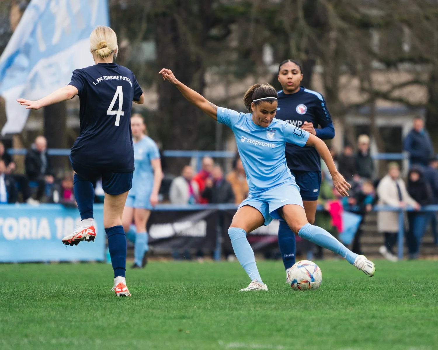Dynamic football action photography showing Viktoria Berlin player in full sprint during a competitive match, captured by a professional sports photographer.