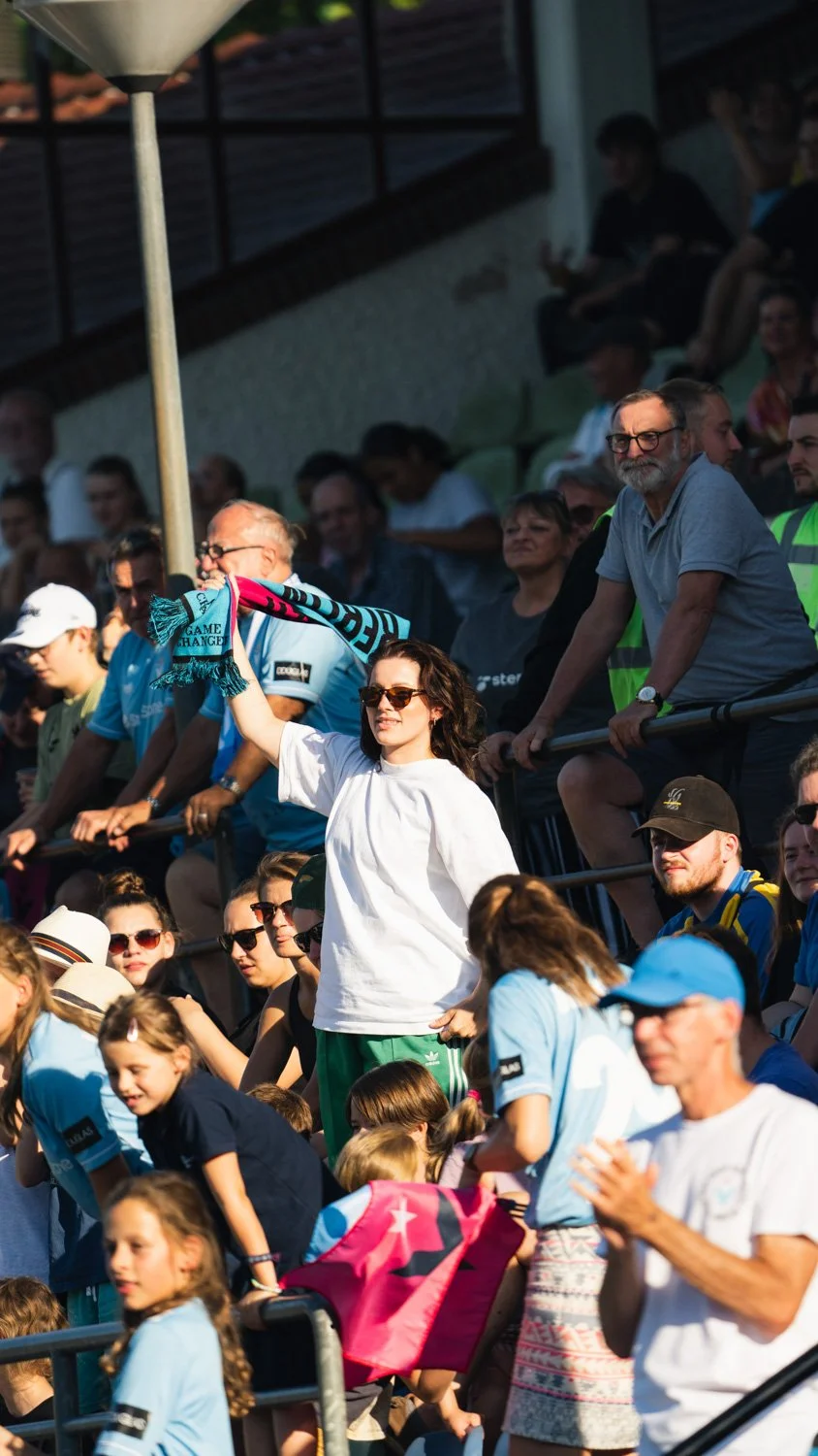 Emotional goal celebration photography of Viktoria Berlin players during a competitive football match, highlighting passion and team spirit.