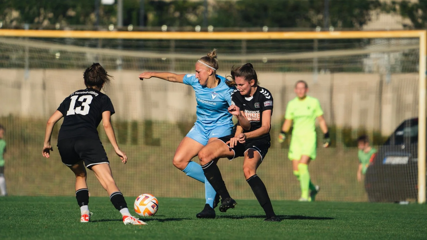 Professional sports photography capturing a decisive defensive moment during a Viktoria Berlin football match.