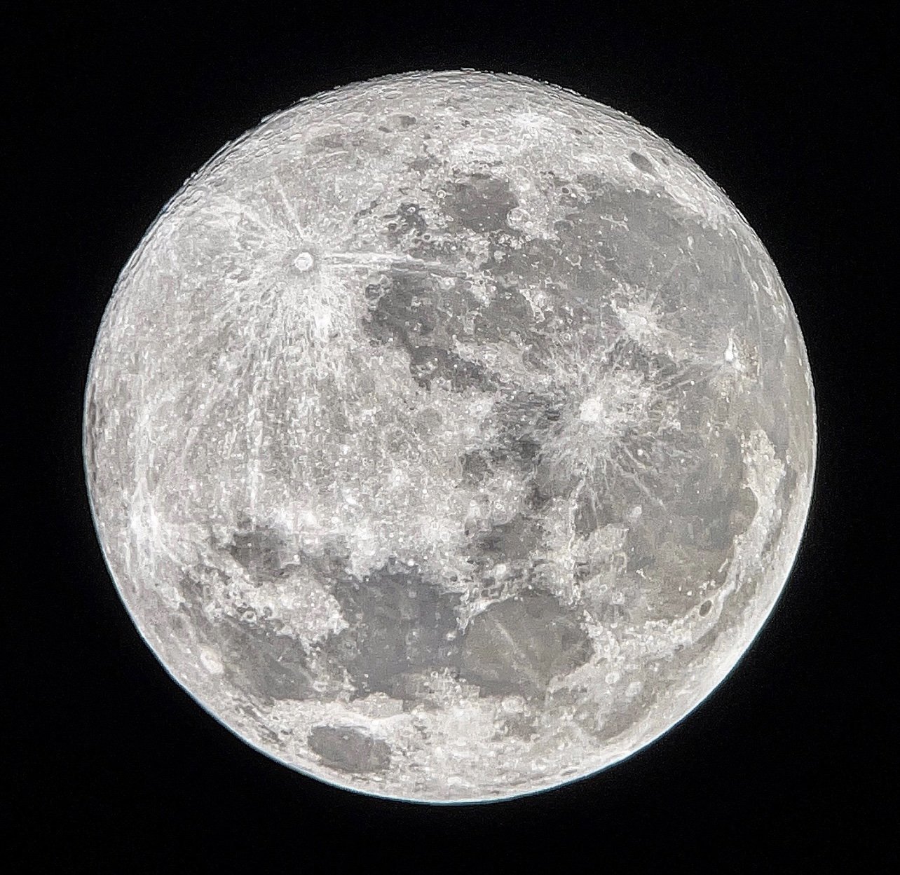 Close-up view of the full moon showing detailed surface with craters and dark maria.