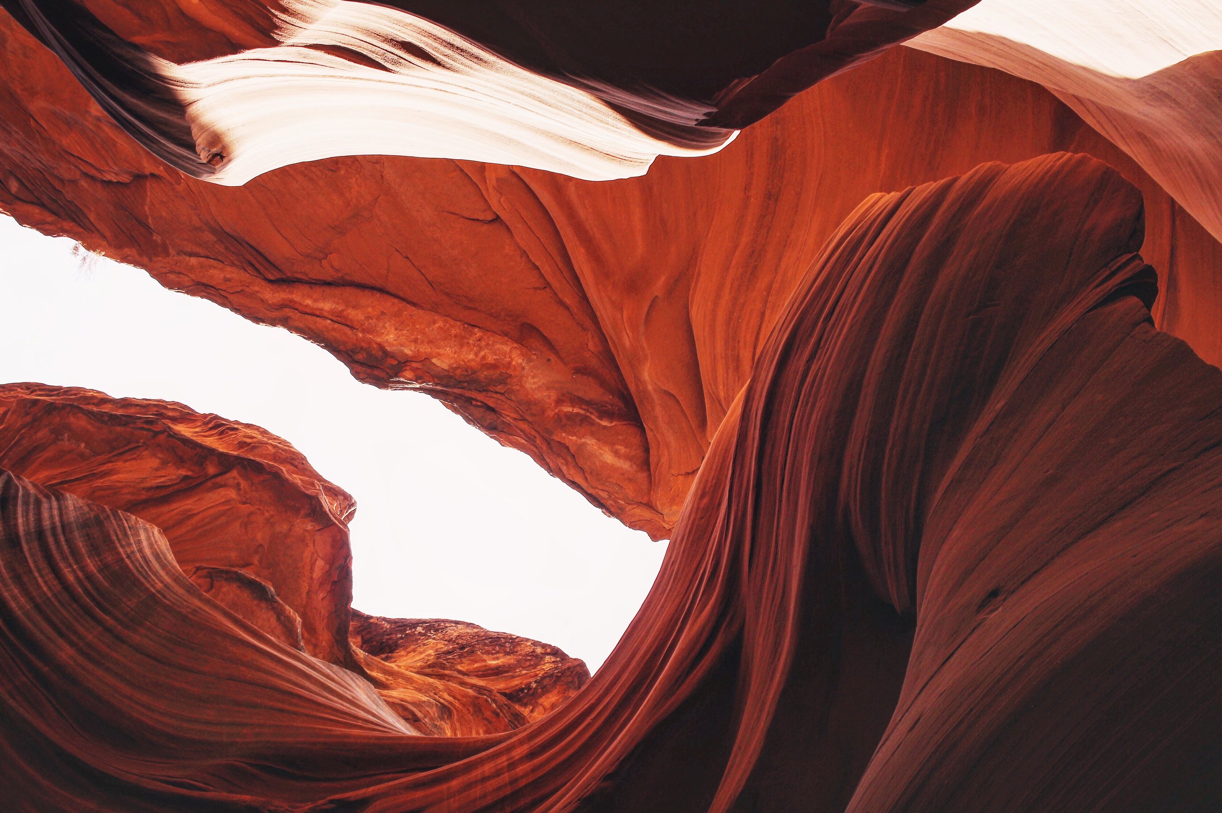 View of the narrow slot canyon walls in Antelope Canyon, featuring smooth, flowing red and orange sandstone formations.