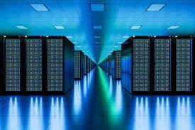 A data center with rows of server racks and blue lighting.