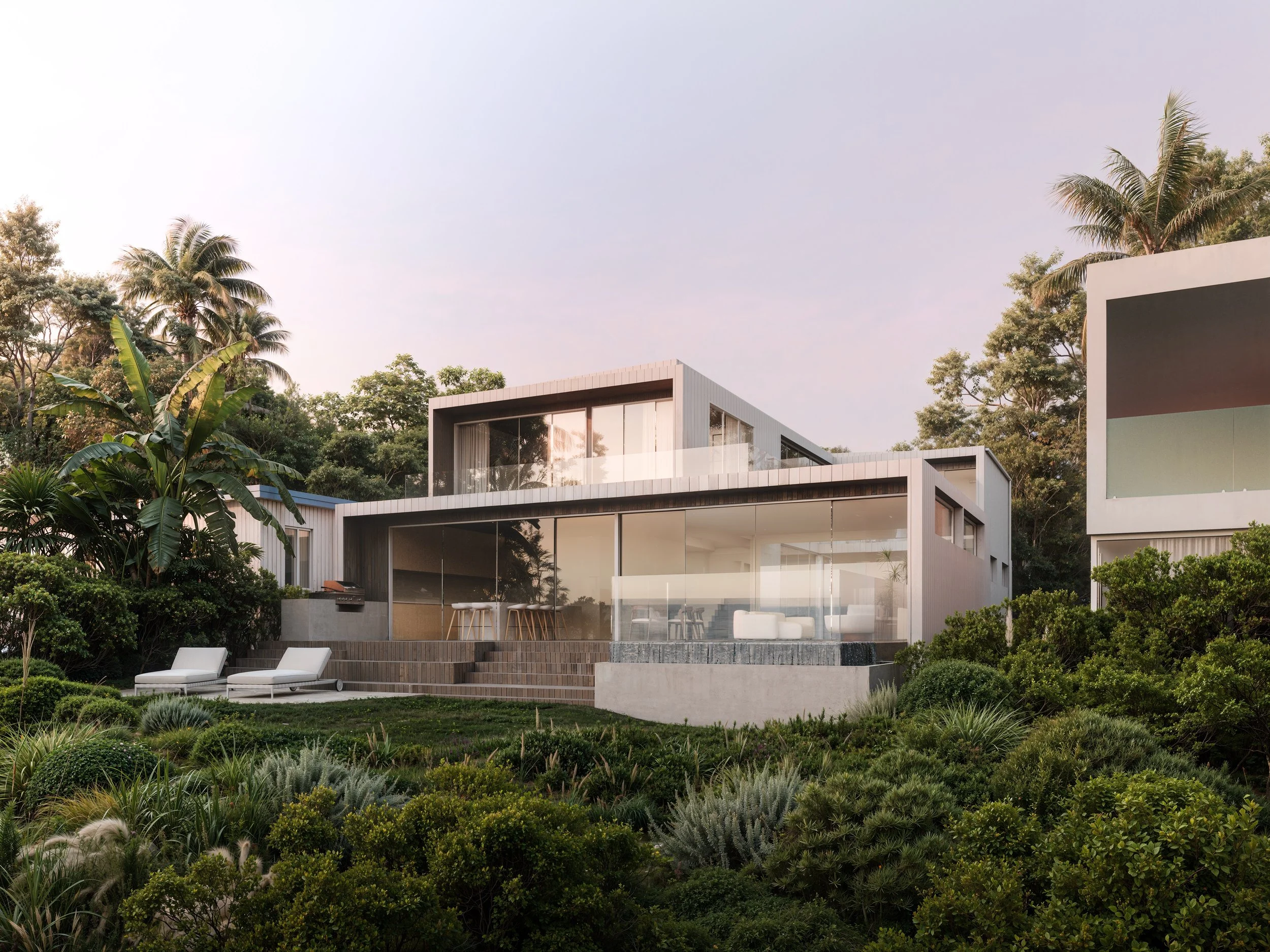 Modern house with large windows, deck, and white exterior, surrounded by lush green landscaping and tall palm trees under a light sky.