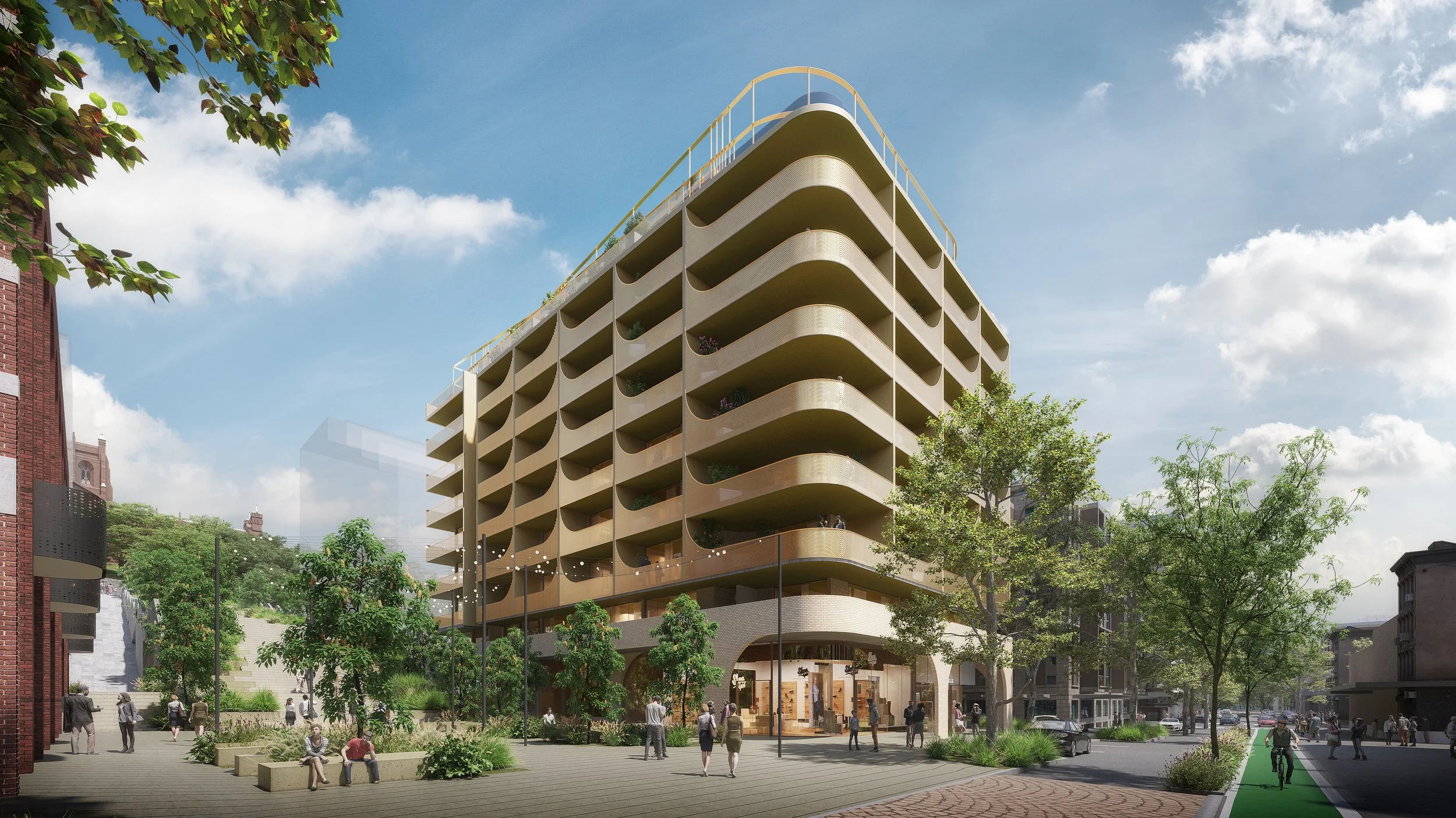 A modern multi-story building with curved balconies, surrounded by trees and a busy street with pedestrians, under a partly cloudy sky.