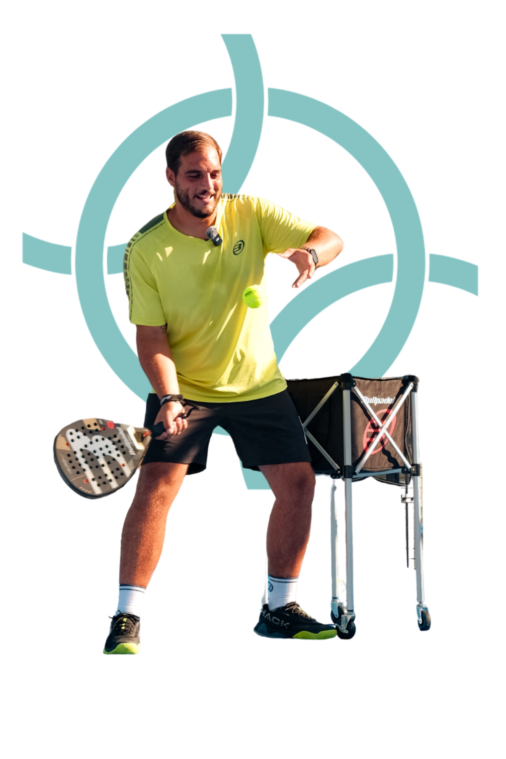 A man in a yellow shirt and black shorts playing pickleball, holding a paddle in his right hand, with a pickleball in mid-air near his chest, standing next to a ball cart, with a stylized teal logo in the background.