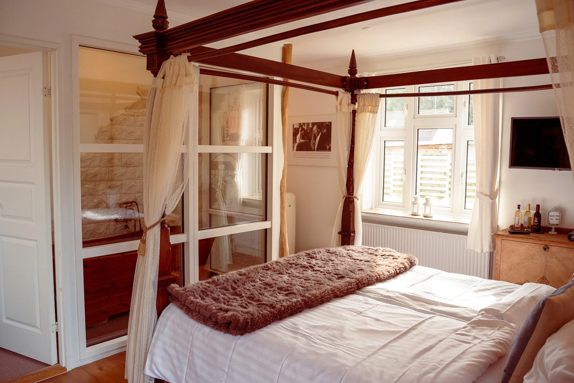 Himmelseng hvide gardiner mahogni naturligt lys hotelværelse