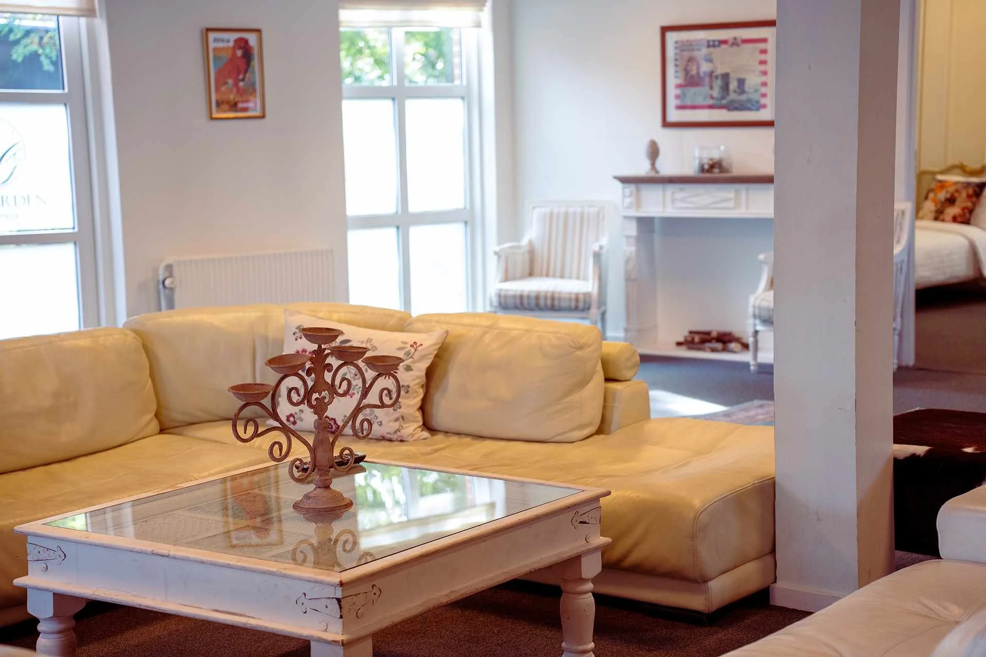 Lys sofastue, creme sofa, glassbord, lysekrone, suite overblik