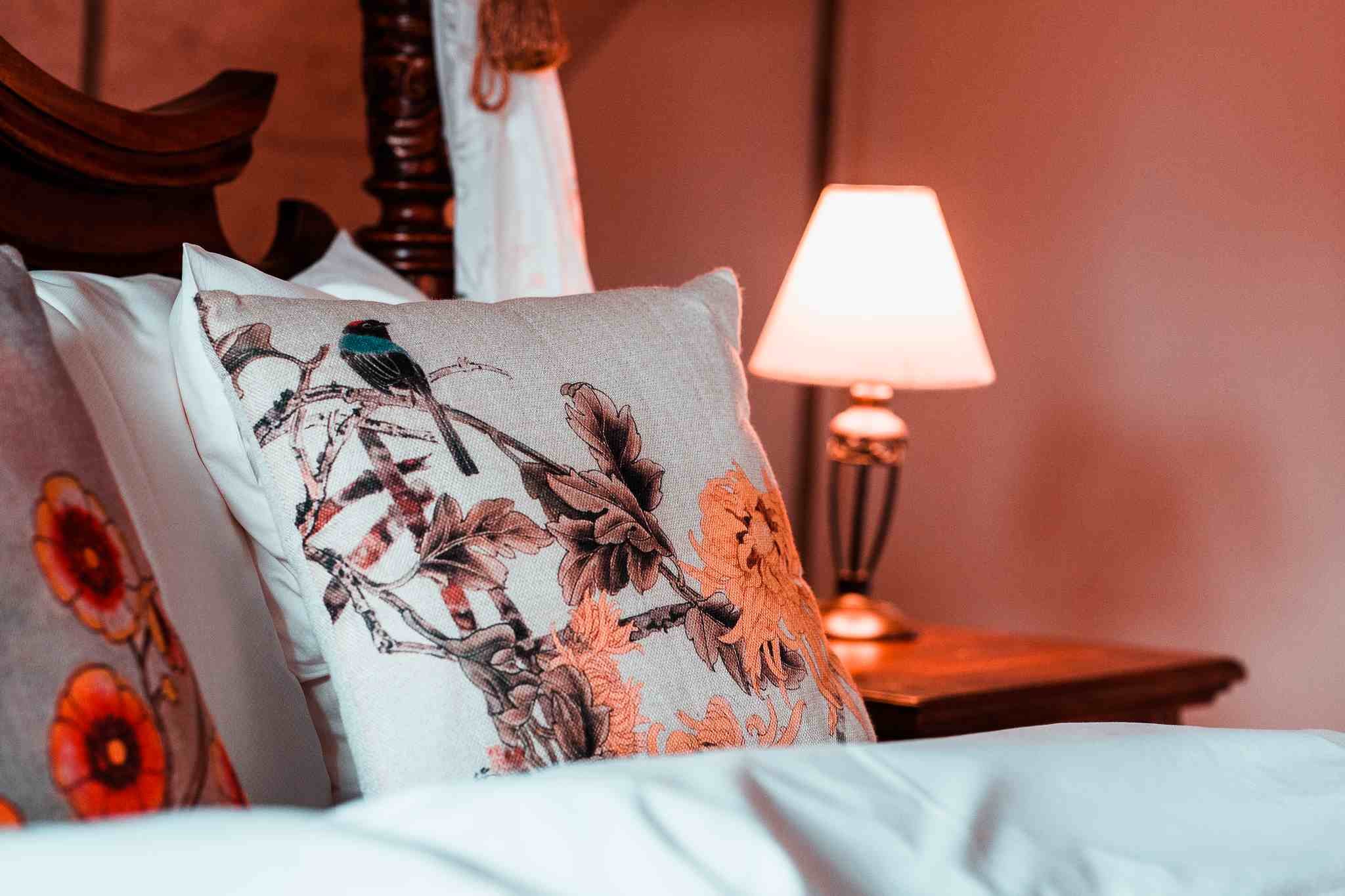 Blomstret pude detalje, sengelampe, varmt aftenlys