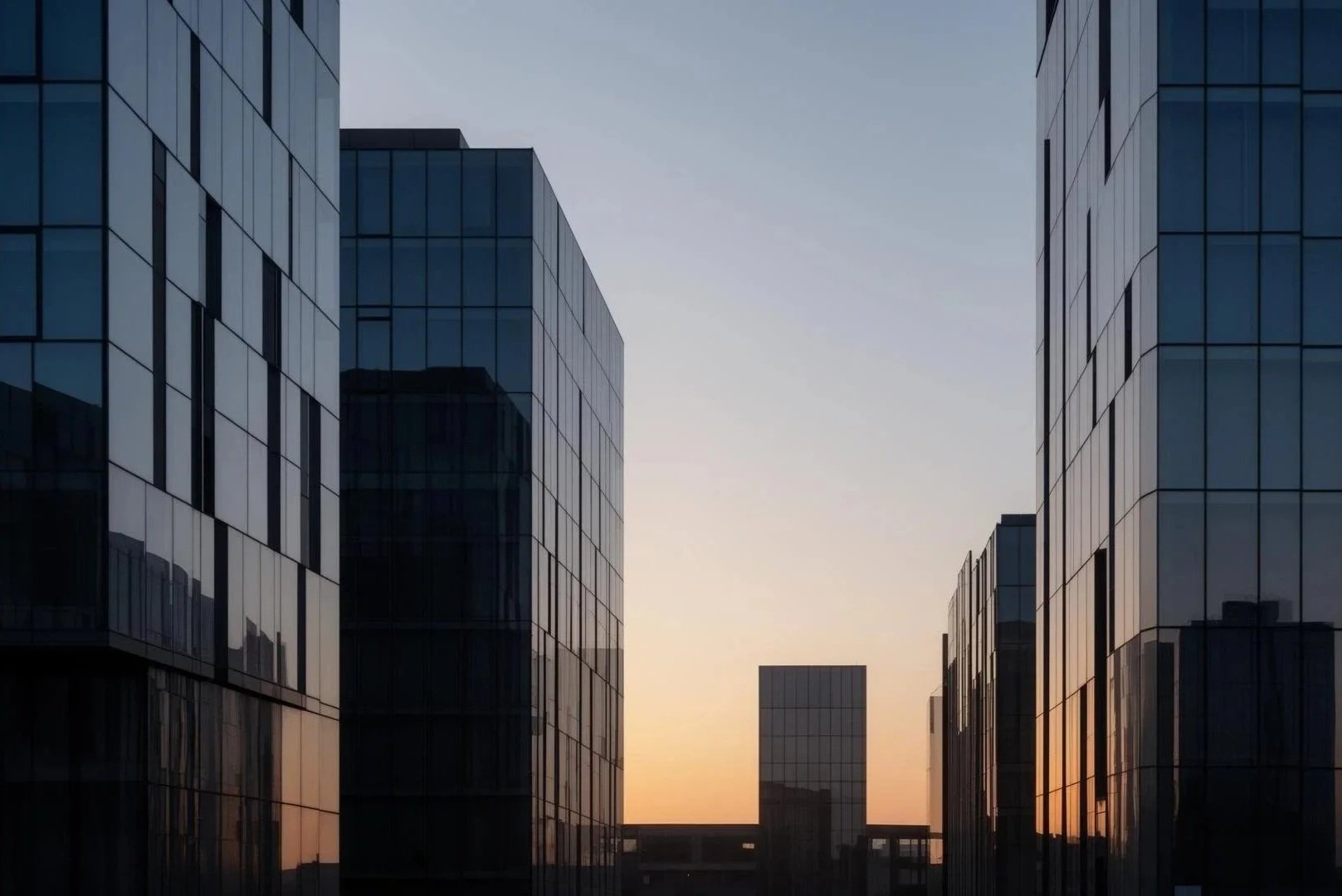 Sunset view between modern glass office buildings.