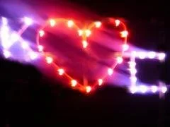 A heart shape created with colorful lights against a dark background.