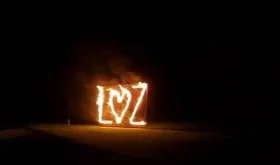 Letters spelling 'LOVE' with a heart symbol in fire rope
