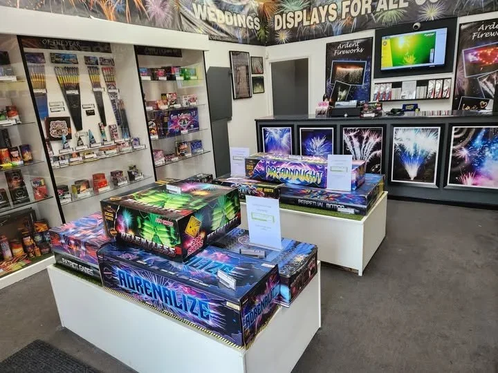 Located at Pocklington Industrial estate outside York. Including large cakes such as 'Adrenalize' and 'Dreadnaught', with other fireworks and sparklers on shelves, and fireworks videos playing on a TV screen.
