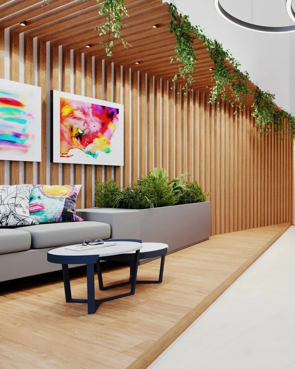 Modern interior waiting area with wooden slat wall, colorful abstract artwork, gray sofa with brightly patterned pillows, black and white coffee tables, lush green plants, hanging greenery from the ceiling.