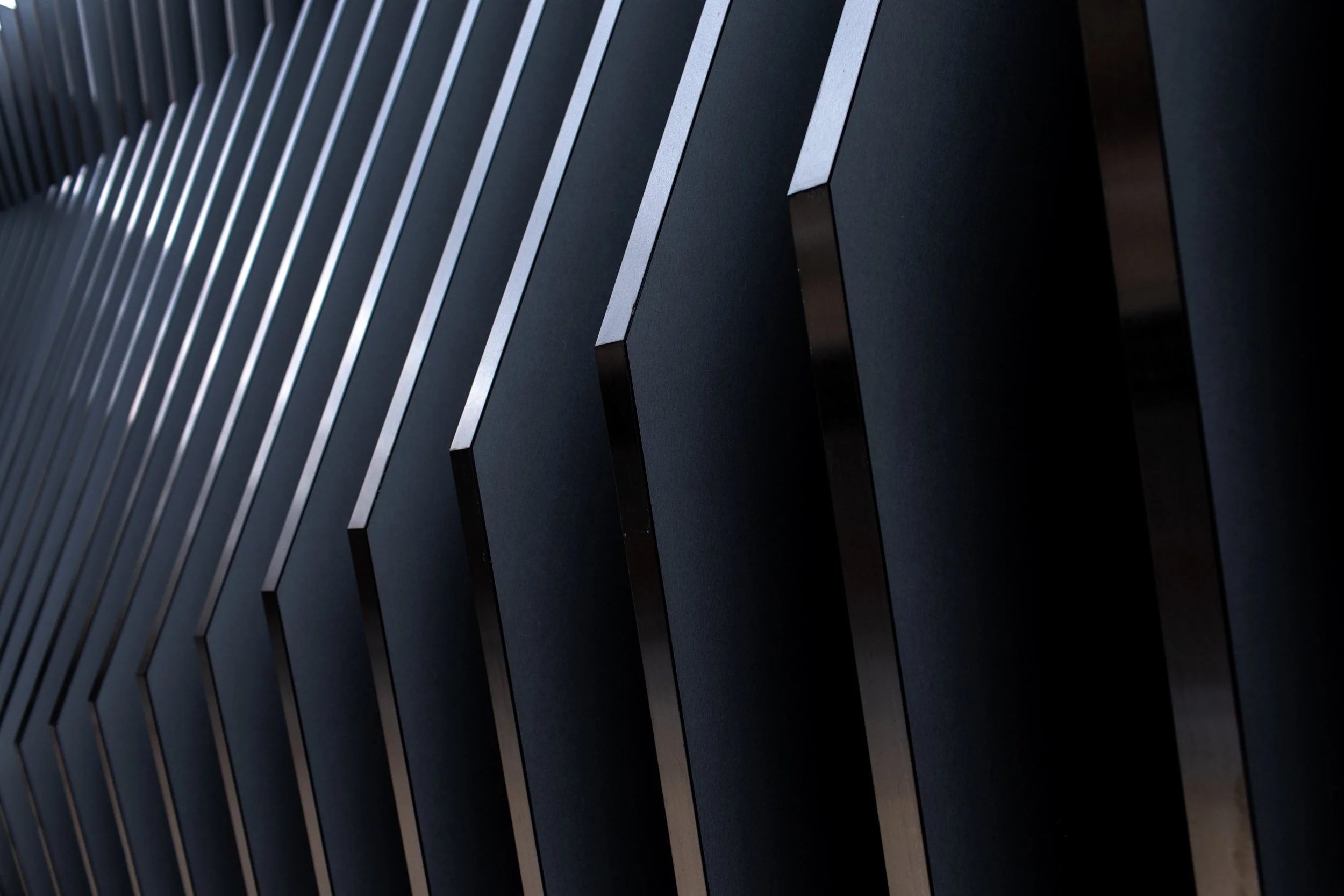 Close-up of a modern black computer server with vertical metal slats.