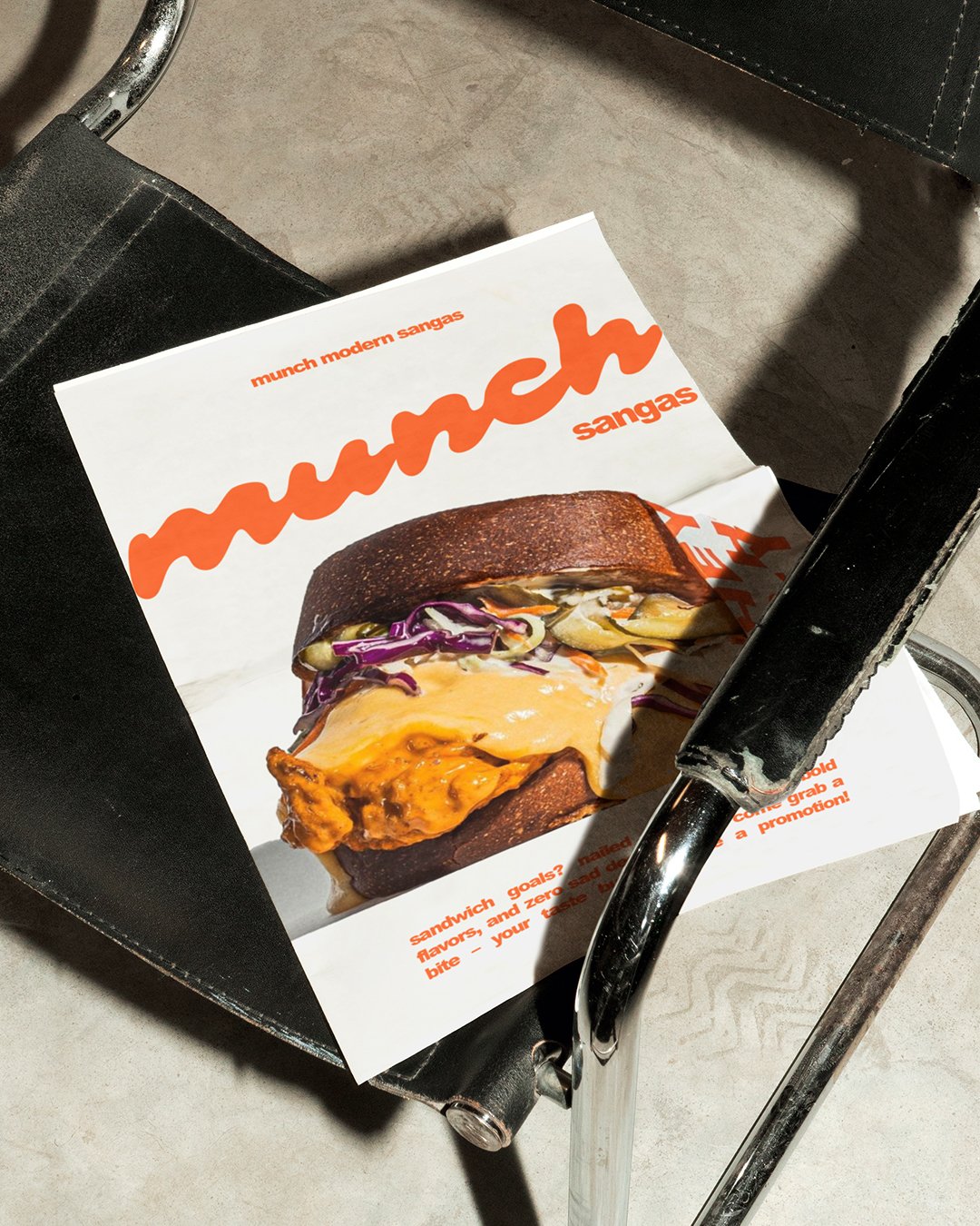 Close-up of a flyer with a cheeseburger on it, resting on a black shopping cart with silver handles.