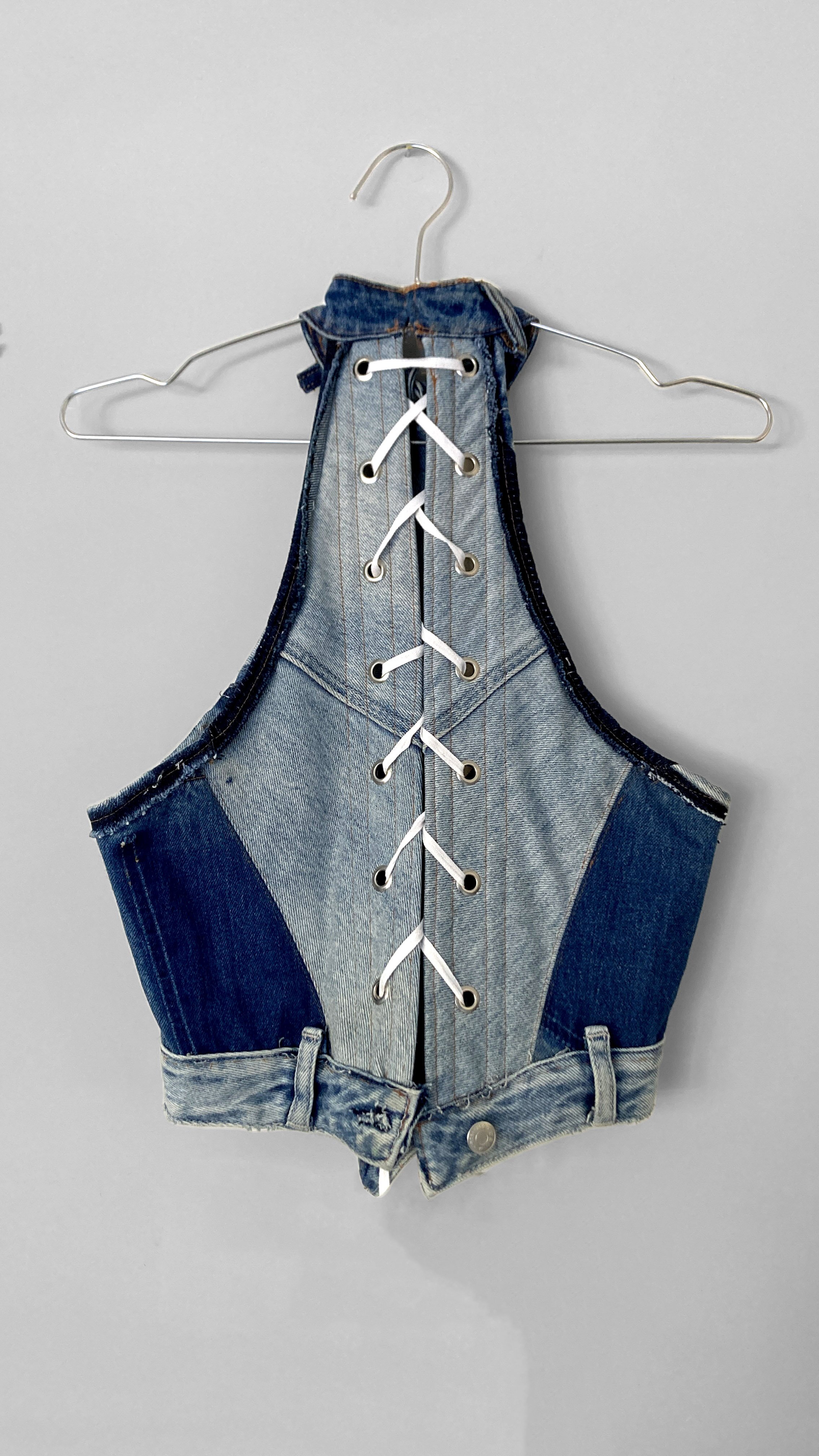 Back view of the upcycled jeans boned bodice. Here shows the corset style fastening, boning channels, more decorative seam matching and the jeans waistband as the hem.