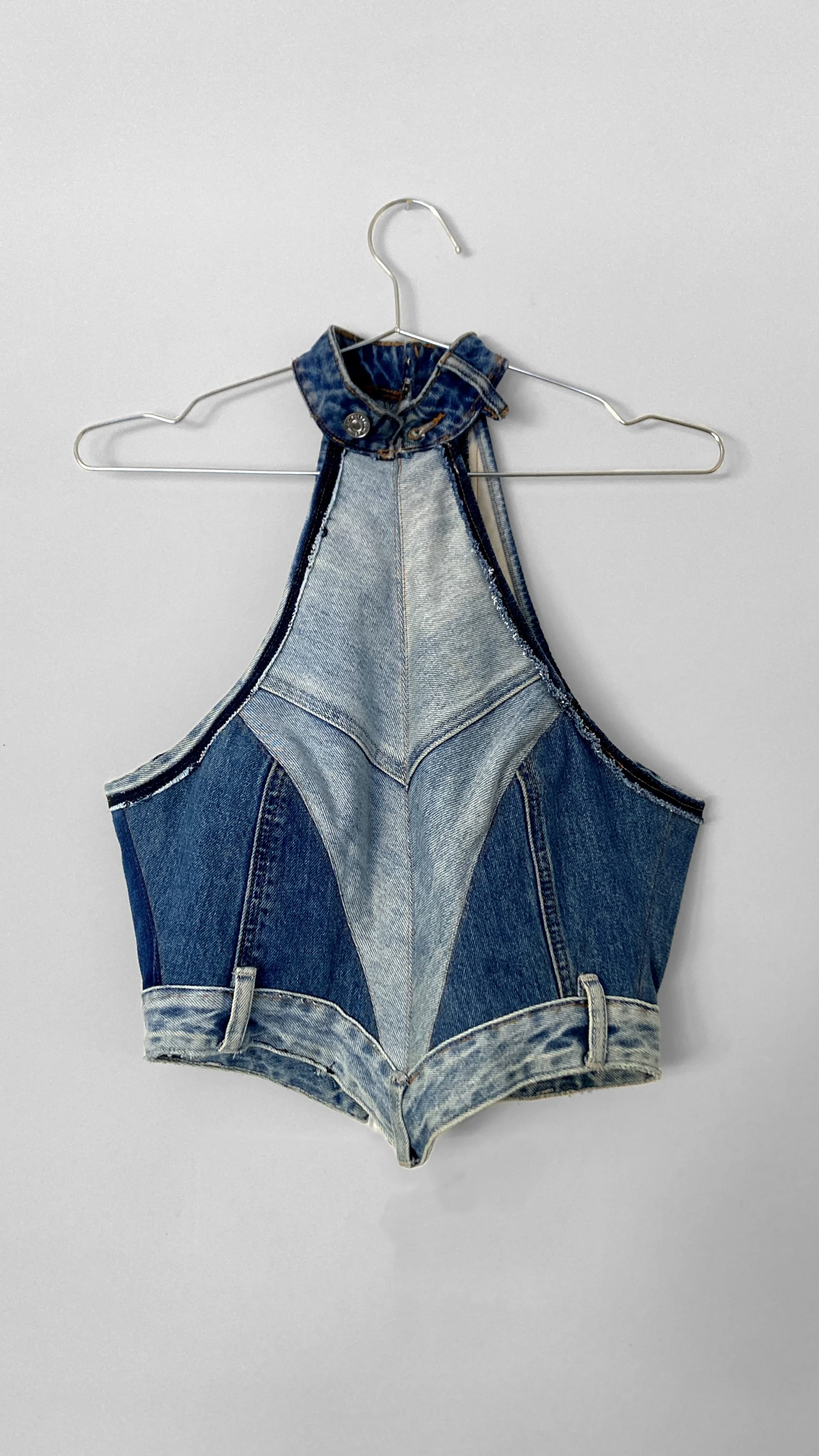 Full view of a bonded bodice made from upcycled denim jeans. Each panel uses different shades, and the original seams are used decoratively. The collar and hem are made from the original jeans waistbands.
