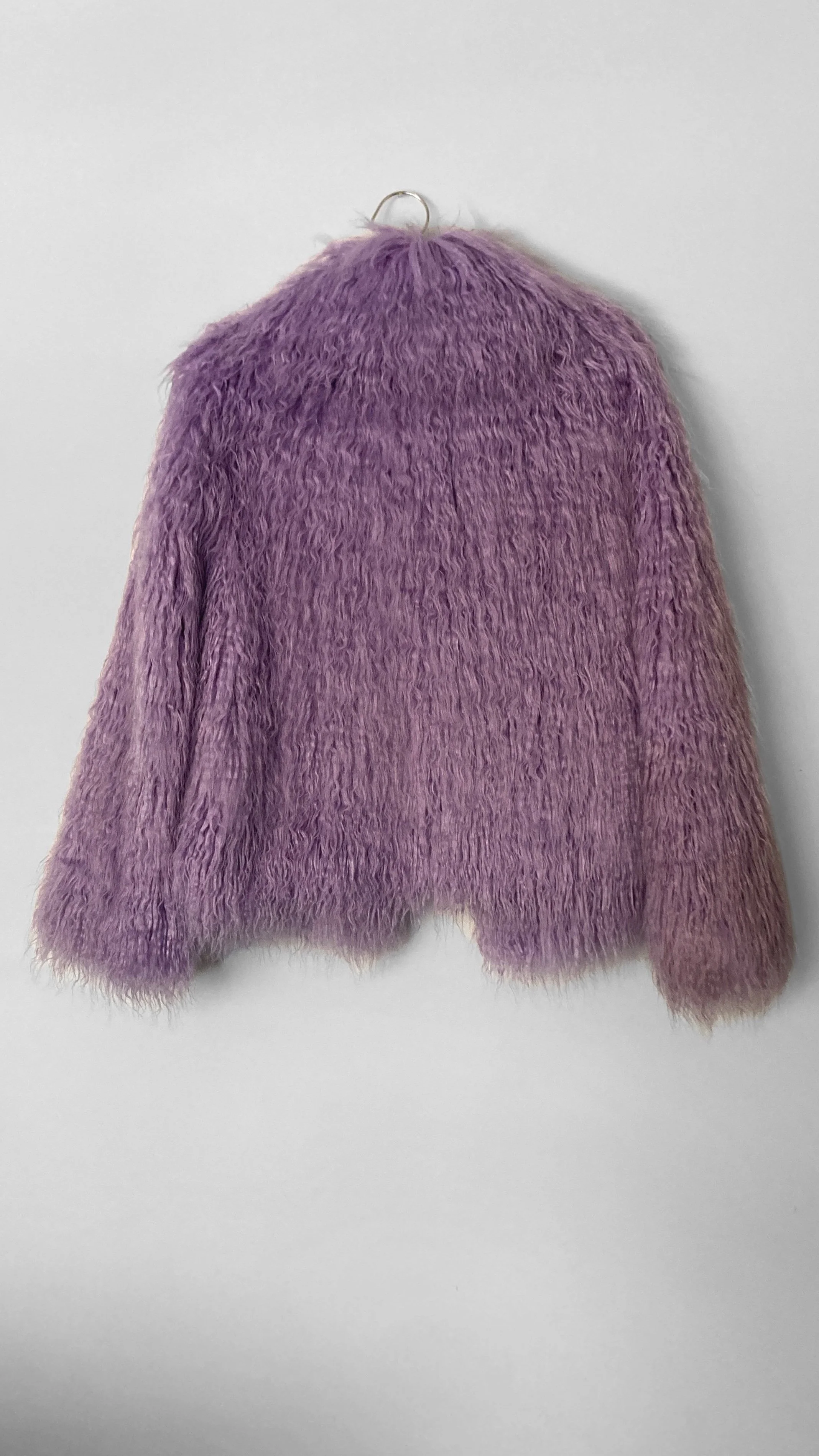 Full back view of a lilac-purple hip length faux fur jacket.