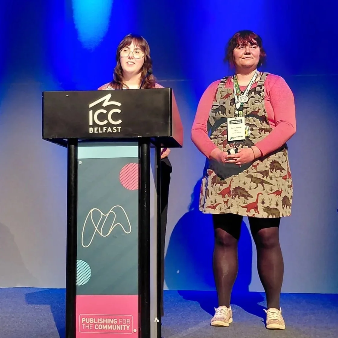 The organisers talking at a conference