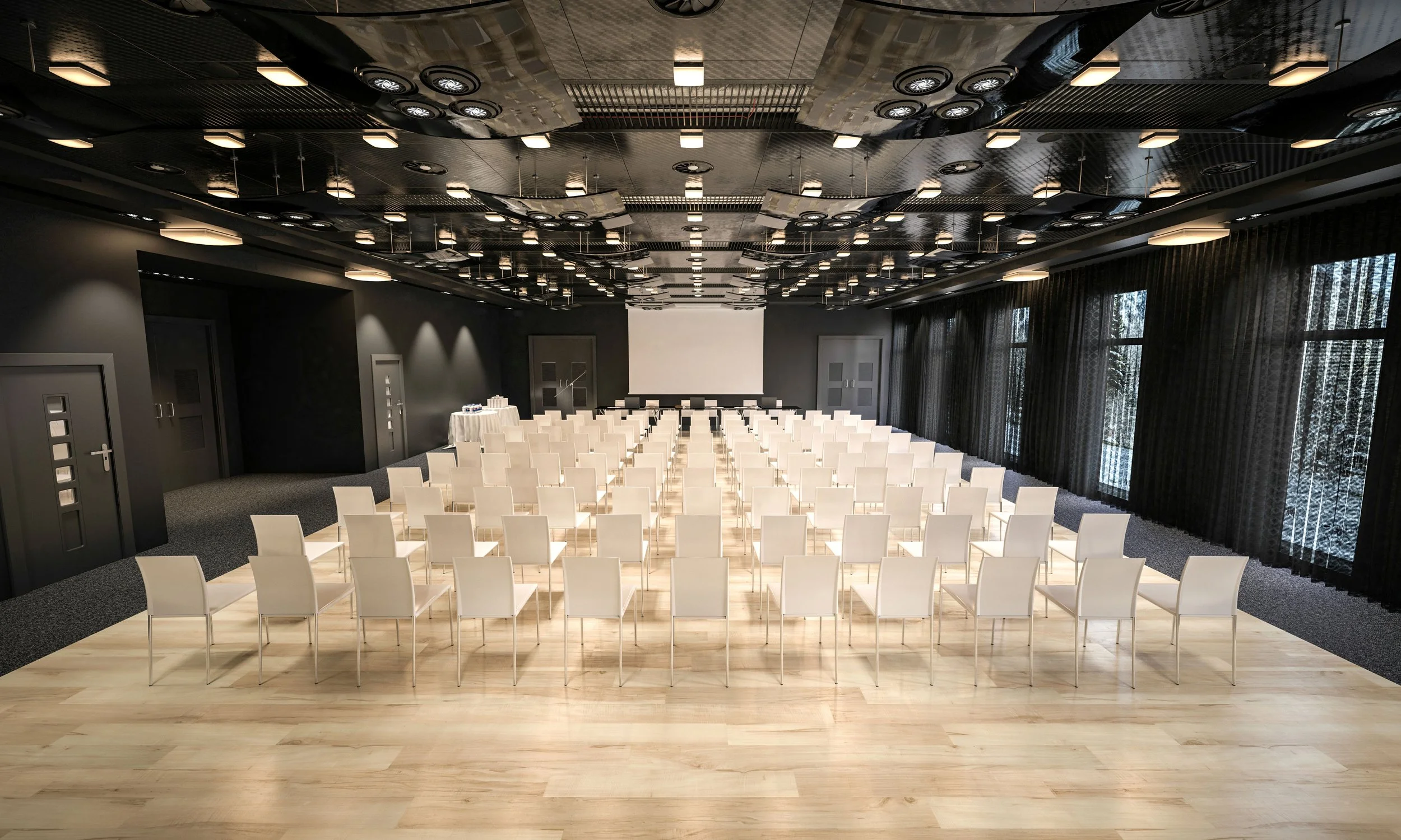 Empty conference room with white chairs arranged in rows facing a large screen, black curtains on windows, black ceiling with lighting fixtures.