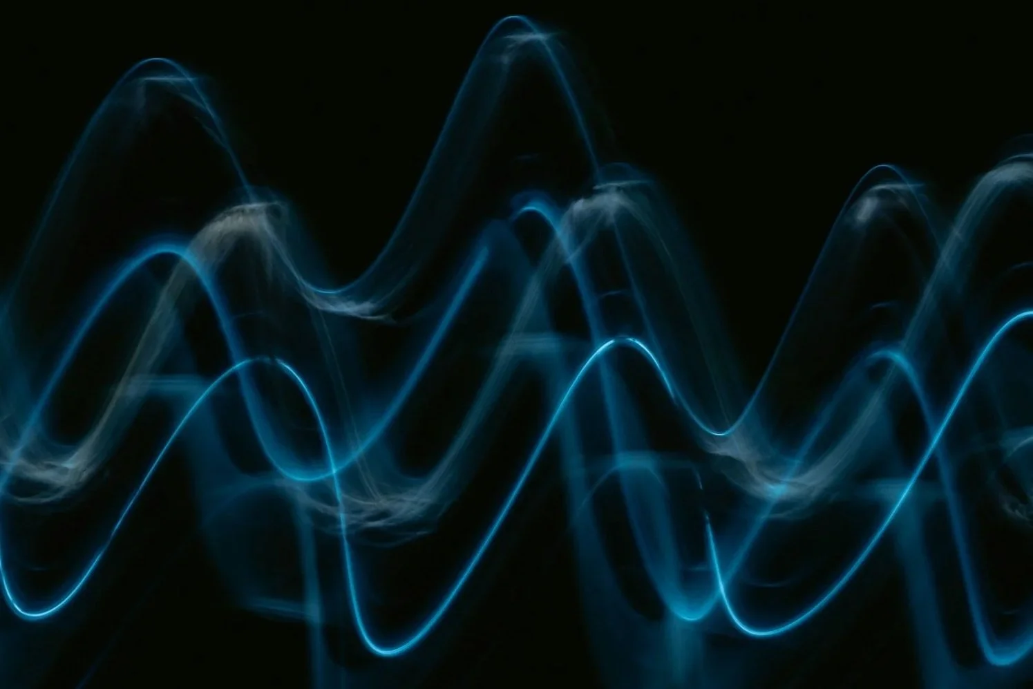 Blue light waves on a black background.