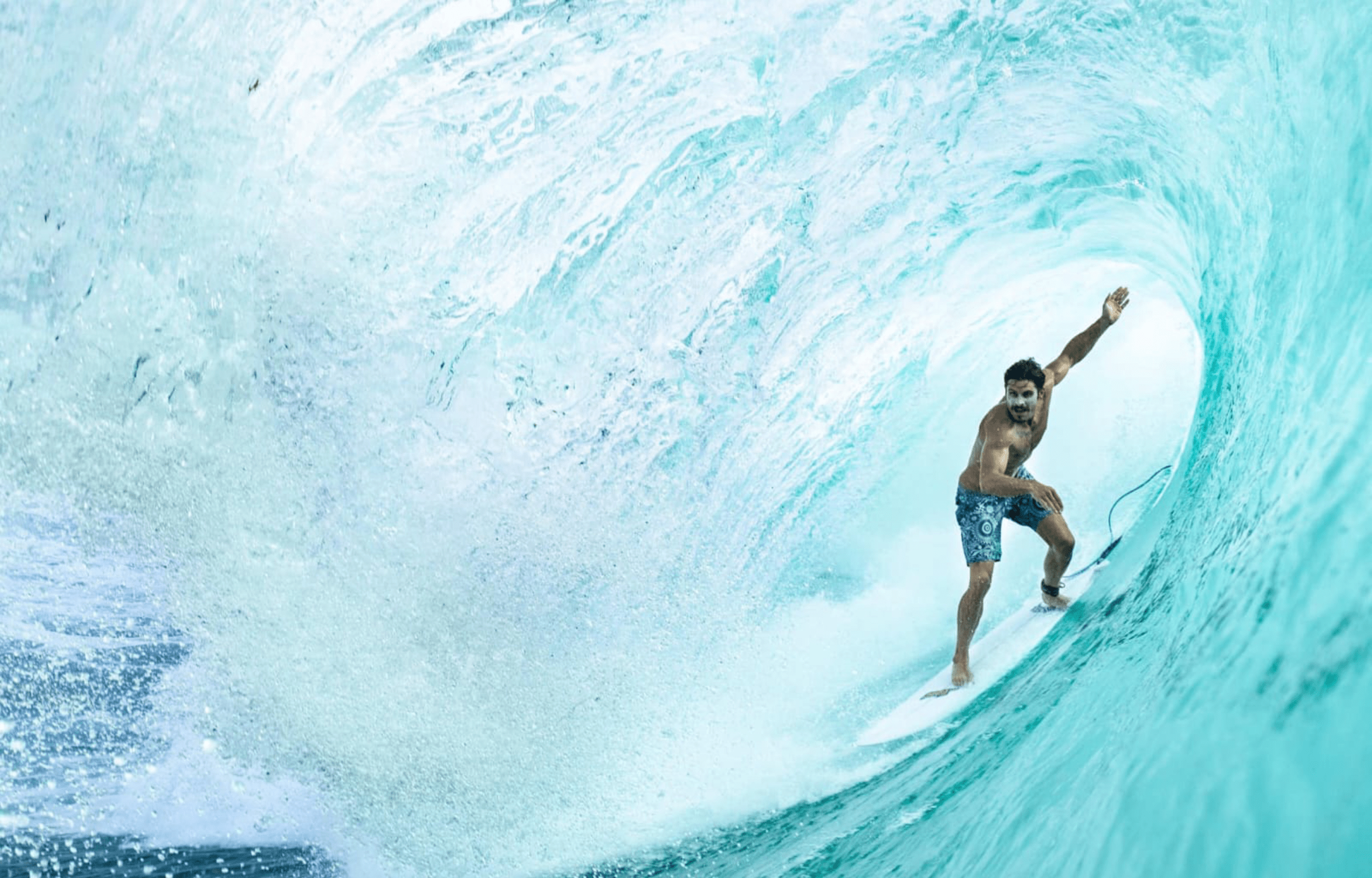 Photo by David Biner showing a man in surfing in a barrel at Desert Point Indonesia