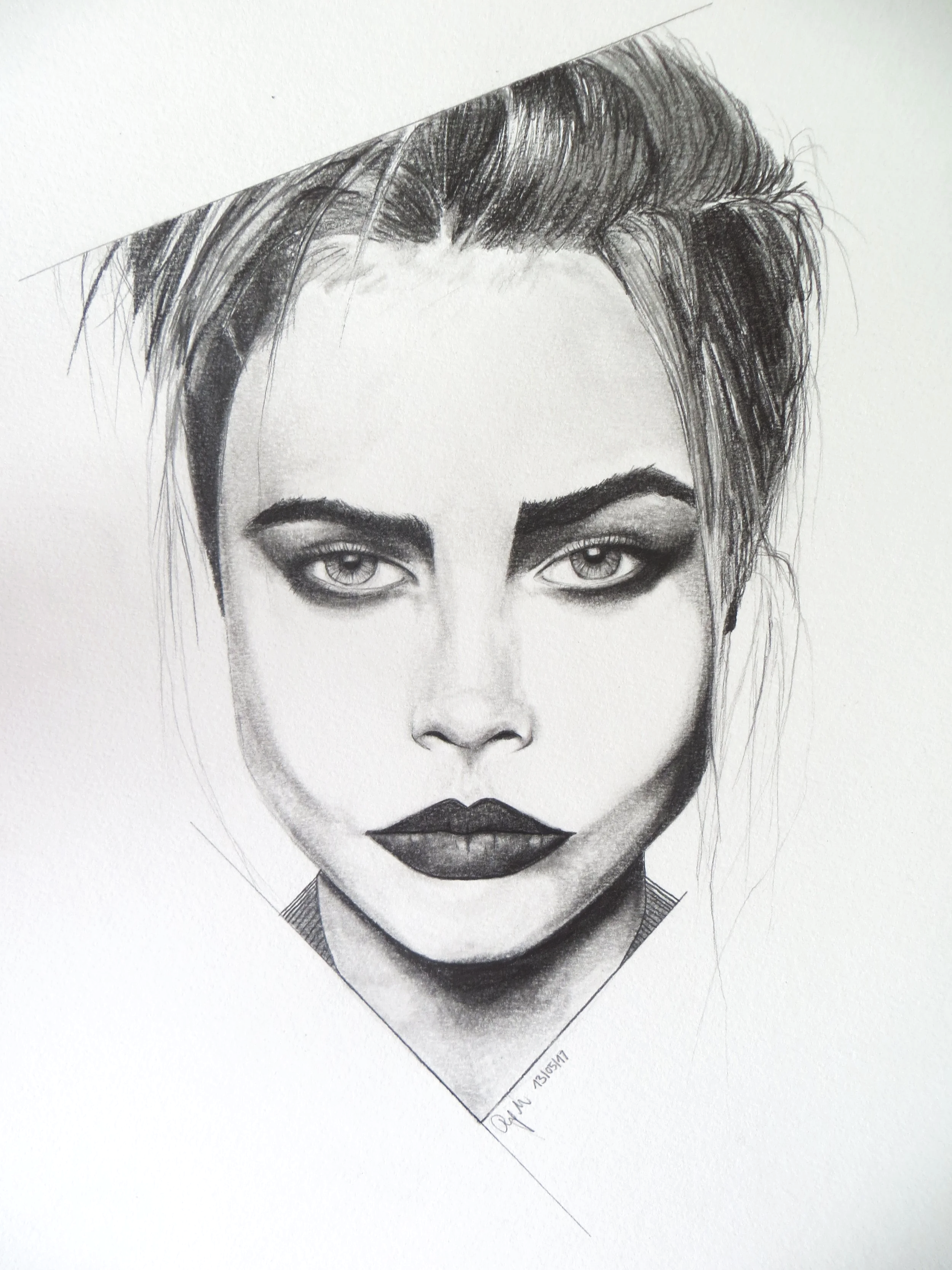 A highly detailed pencil drawing of a woman's face (Cara Delevingne) with intense eyes, dark eyebrows, and full lips, with her hair styled back.