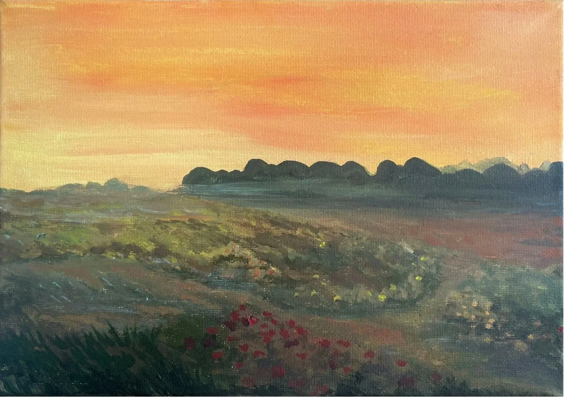 Landscape painting of a field at sunset with green vegetation, red flowers, and a tree line in the distance under a pink-orange sky.
