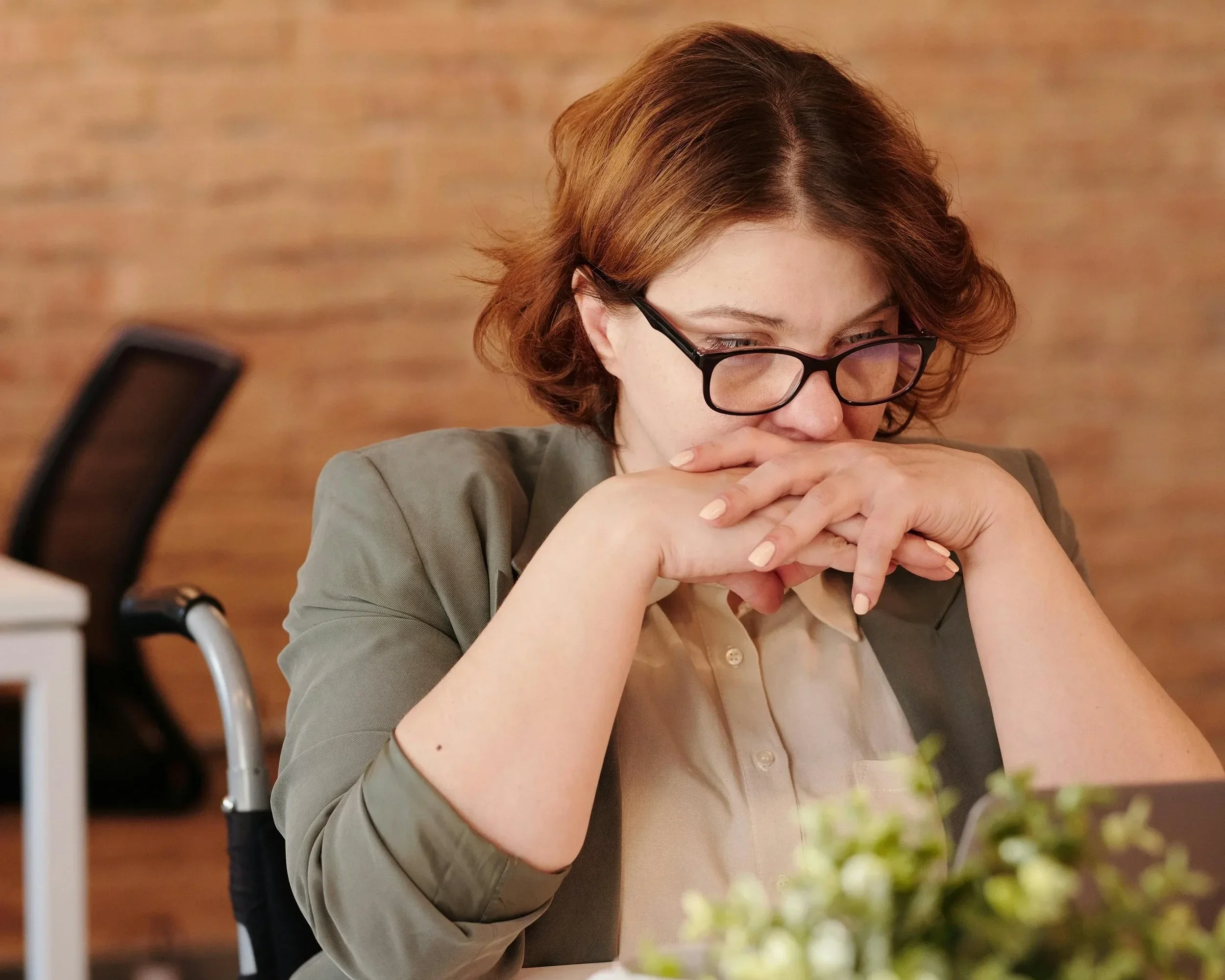 A contemplative professional in Raleigh, NC, assessing her mental health needs and considering a shift from weekly processing to intensive nervous system rewiring.