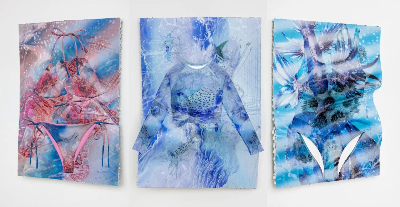 Three mixed media art pieces with blue and pink tones hung on a white wall, featuring abstract patterns, mesh textures, and imagery of a swimsuit, a human figure, and a tropical fish.